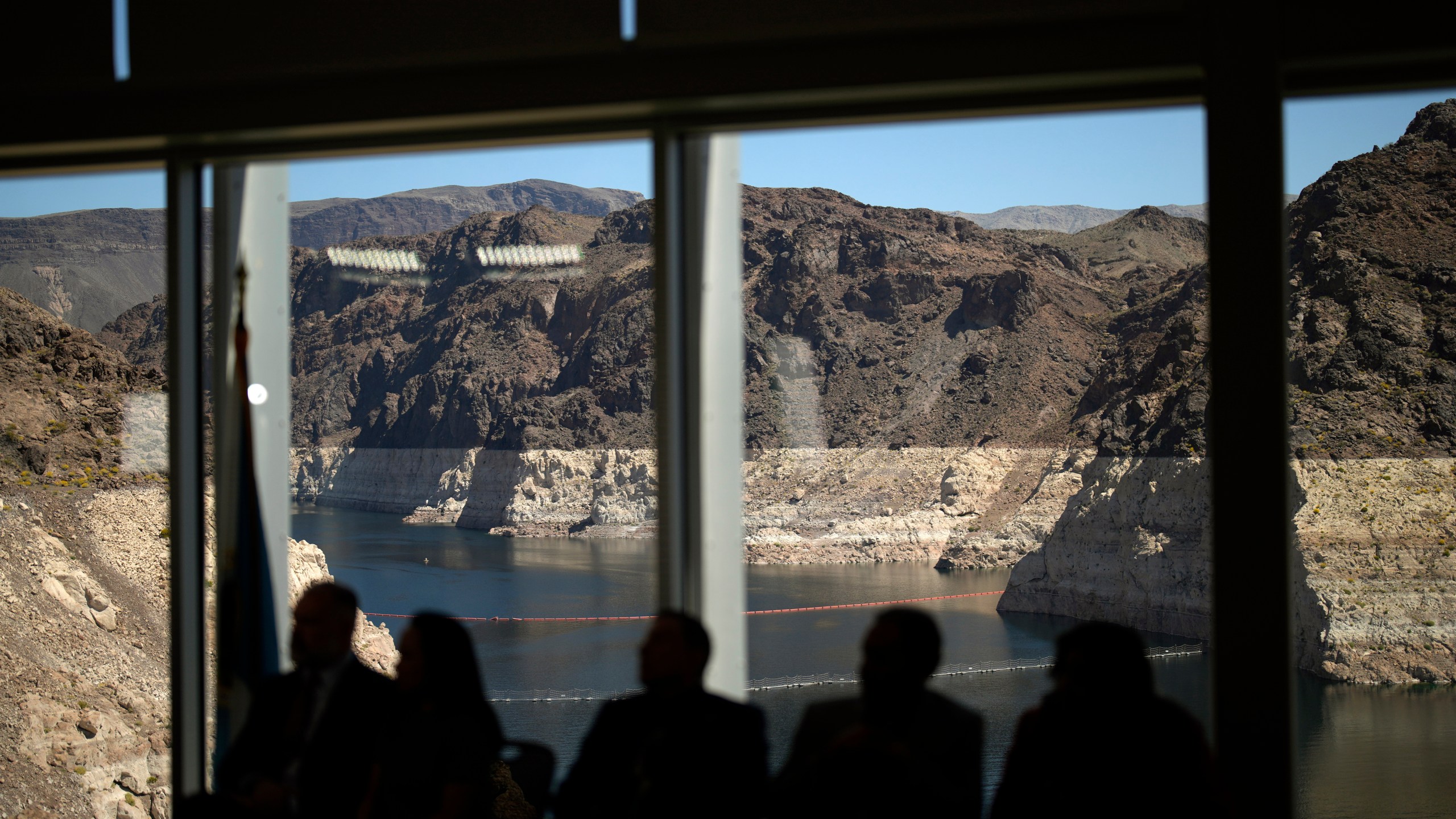 Officials listen during a news conference on Lake Mead at the Hoover Dam