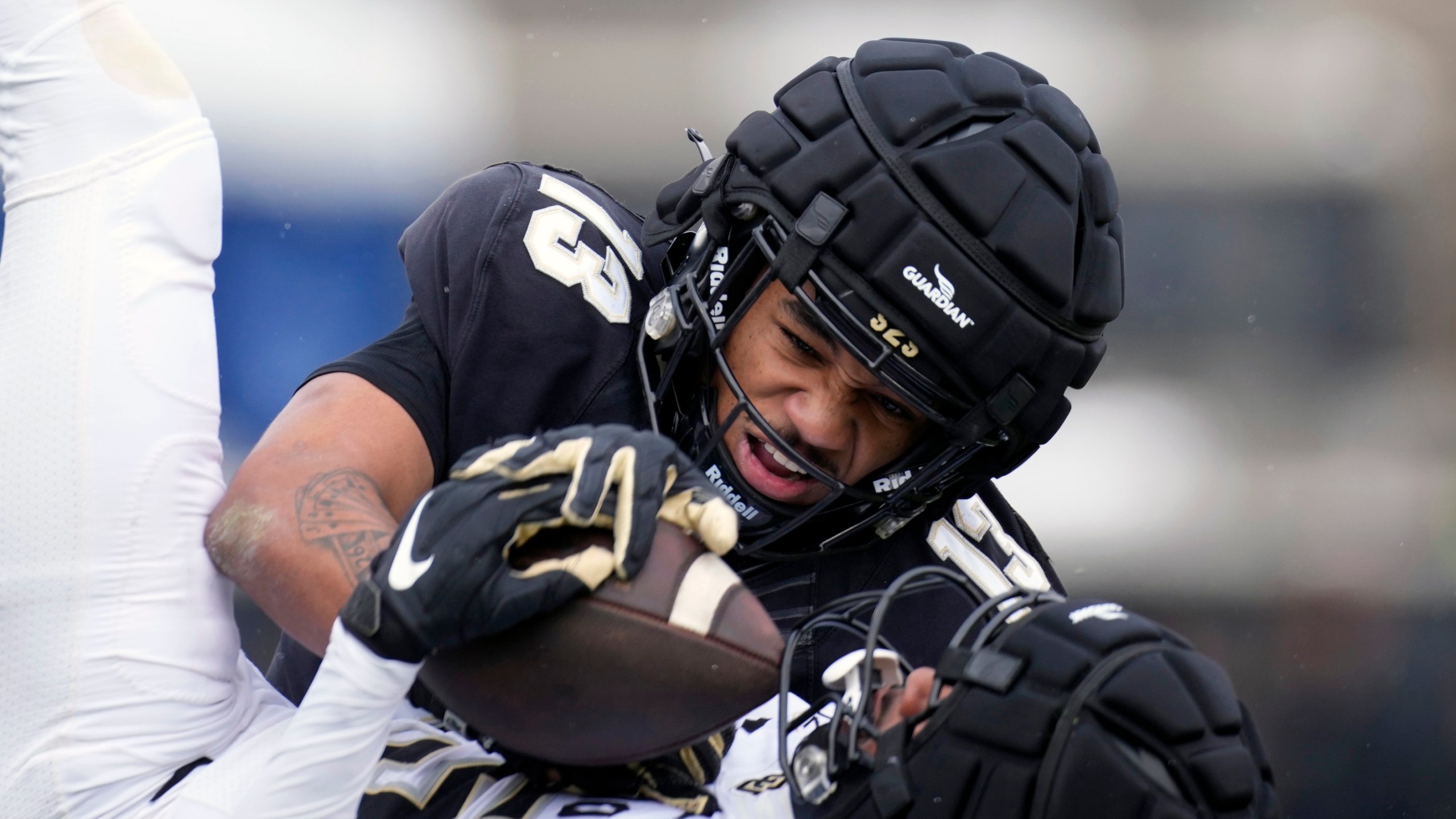 Colorado wide receiver Montana Lemonious-Craig, front, pulls in a pass as cornerback Tayvion Beasley defends