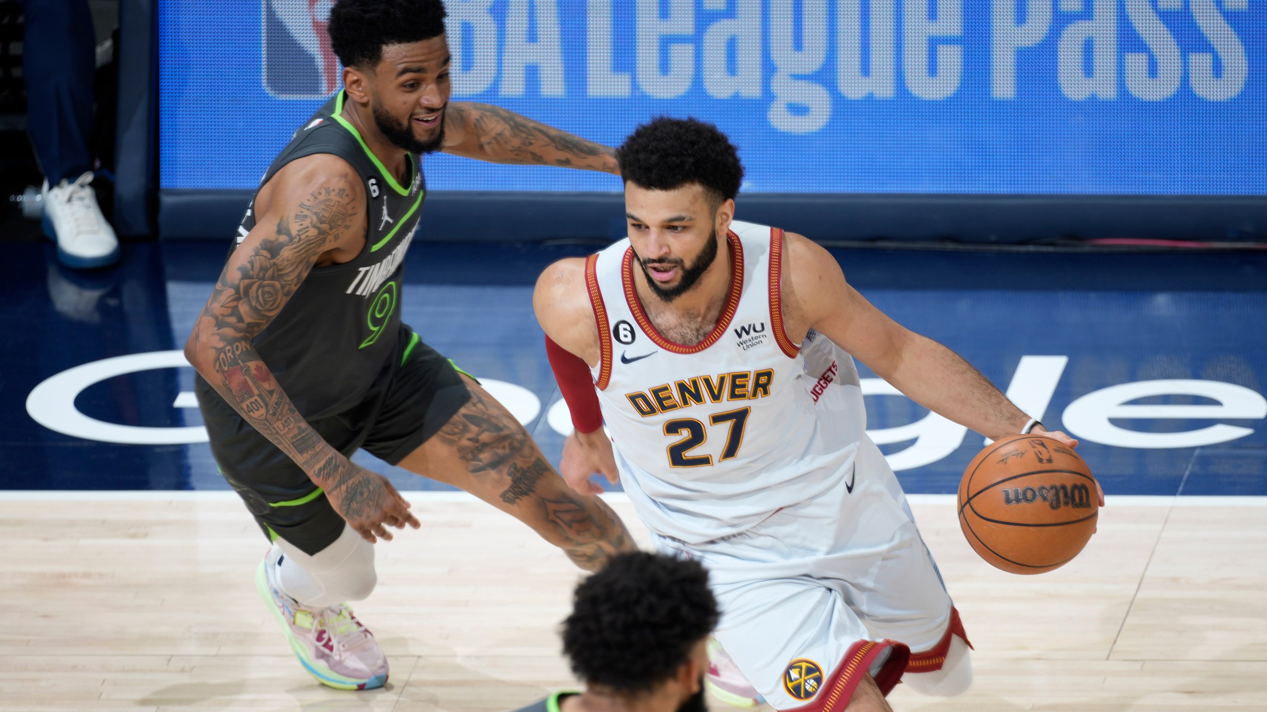 Denver Nuggets guard Jamal Murray drives past Minnesota Timberwolves guard Nickeil Alexander-Walker