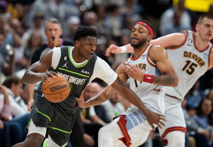 Minnesota Timberwolves guard Anthony Edwards, left, drives against Denver Nuggets forward Bruce Brown and center Nikola Jokic, right