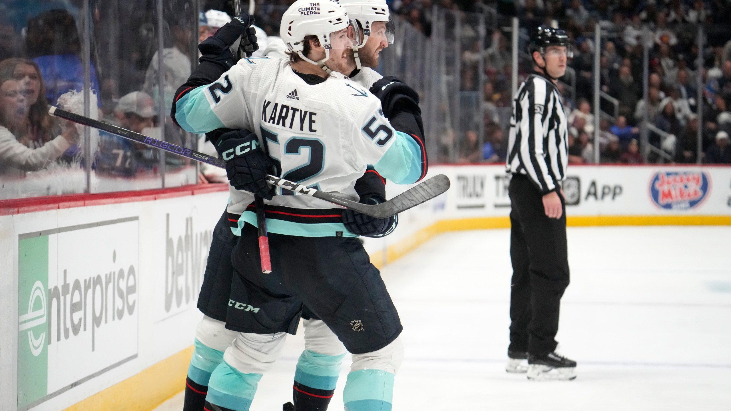 Seattle Kraken forward Tye Kartye, front, celebrates his goal against the Colorado Avalanche with defenseman Will Borgen