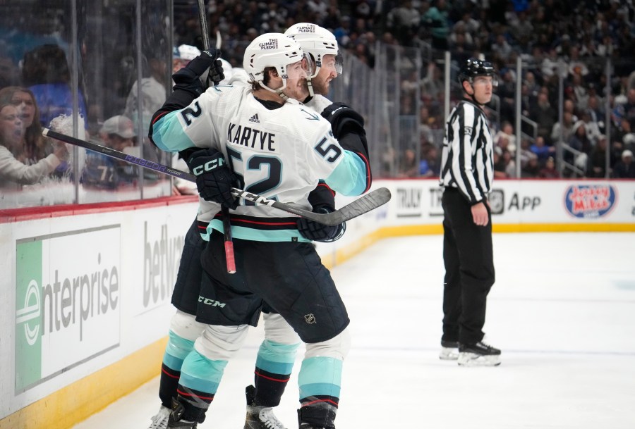 Seattle Kraken forward Tye Kartye, front, celebrates his goal against the Colorado Avalanche with defenseman Will Borgen