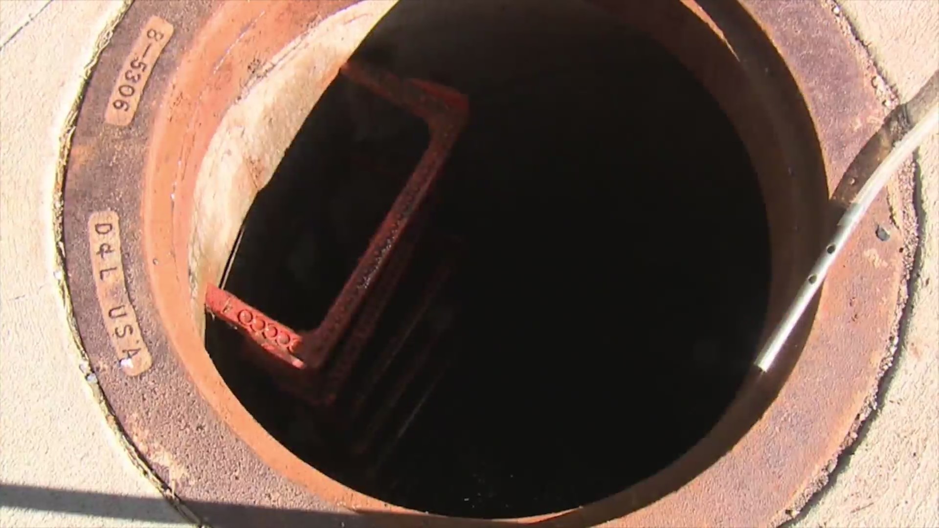 A look down into an open sewage hole