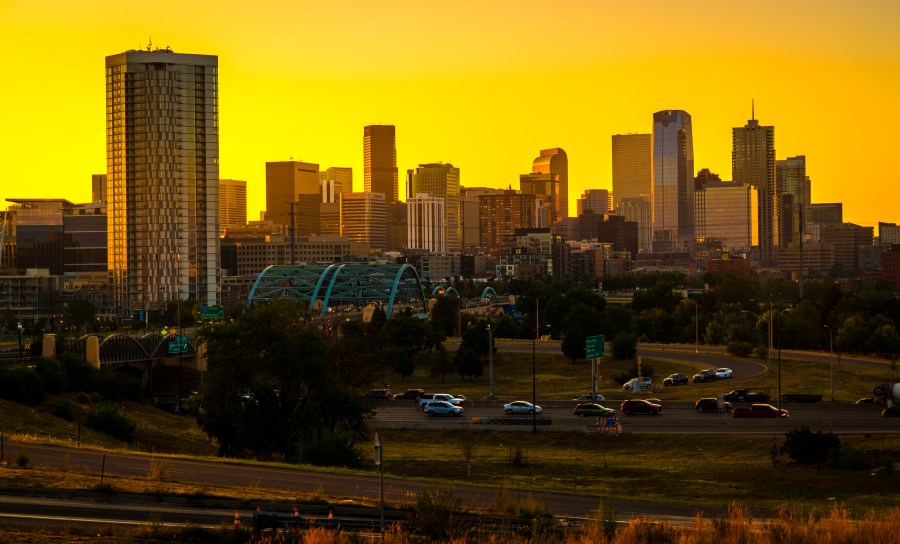 Gold sunrise colors over Denver Colorado skyline cityscape nightscape sunrise