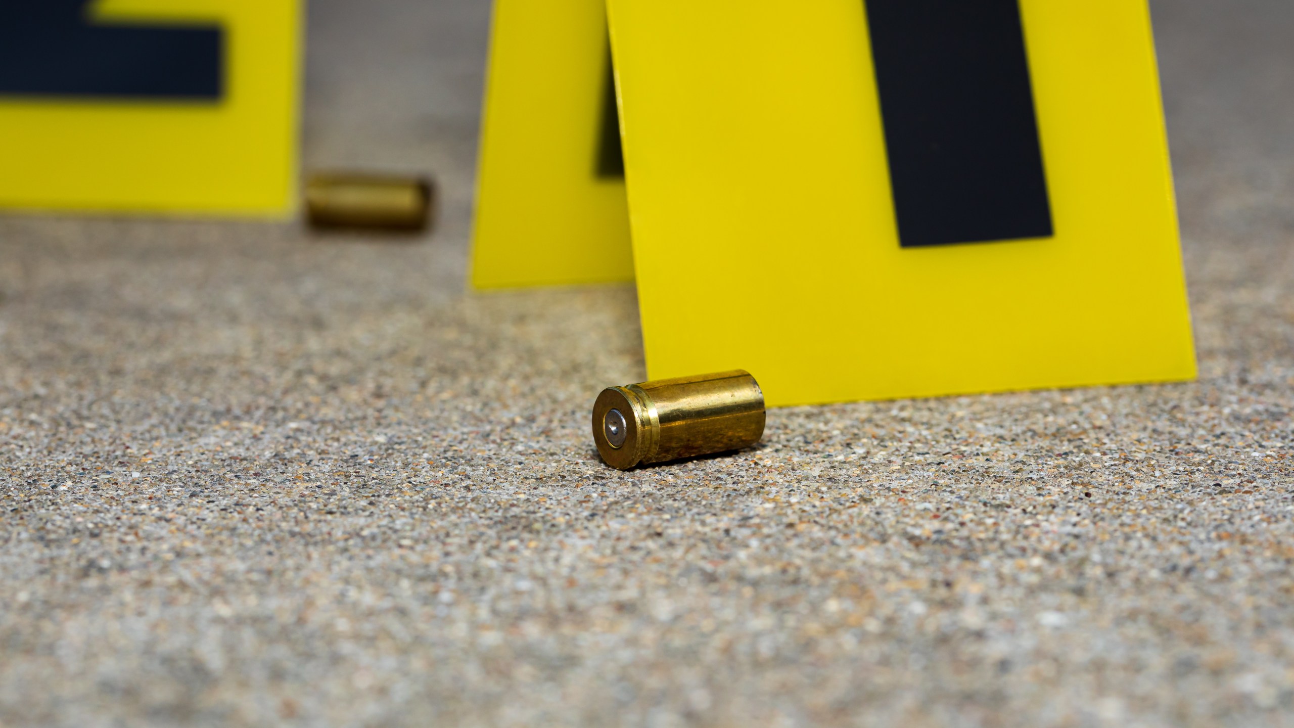 Gun shell casing at crime scene. Gun violence, mass shooting and homicide investigation concept.