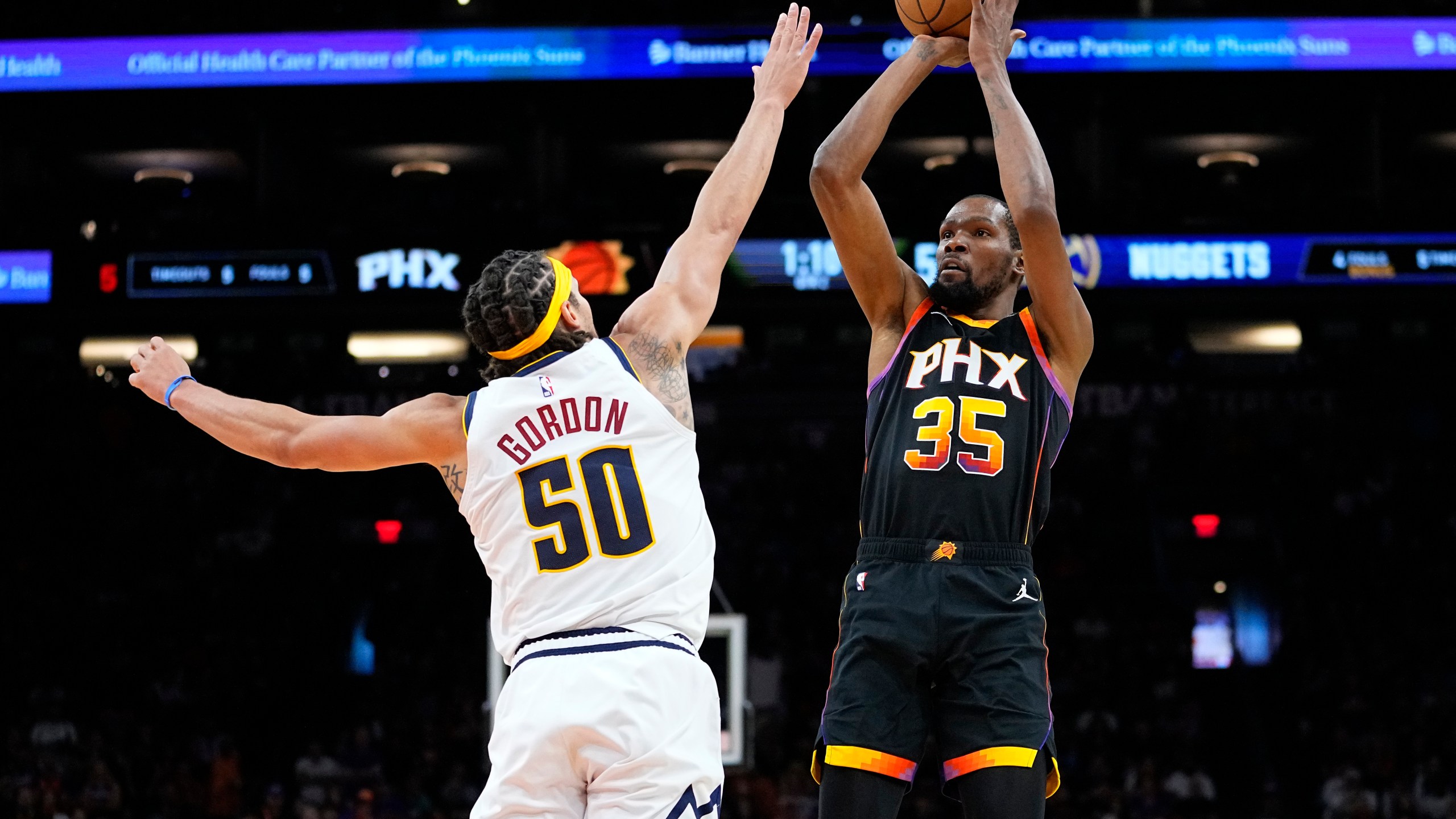 Phoenix Suns forward Kevin Durant (35) shoots over Denver Nuggets forward Aaron Gordon (50) during the first half of Game 4 of an NBA basketball Western Conference semifinal game, Sunday, May 7, 2023, in Phoenix. (AP Photo/Matt York)