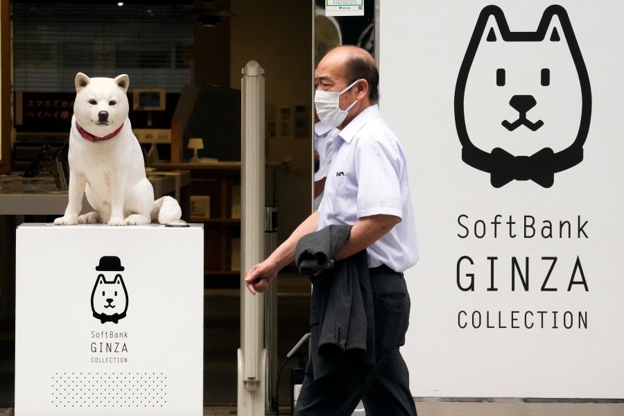 FILE - A man walks past a SoftBank shop in Tokyo on July 29, 2021. Japanese technology investor SoftBank Group reported Thursday, May 11, 2023, a loss of 970 billion yen ($7 billion) for the fiscal year that just ended — the second year in a row of red ink. (AP Photo/Eugene Hoshiko, File)