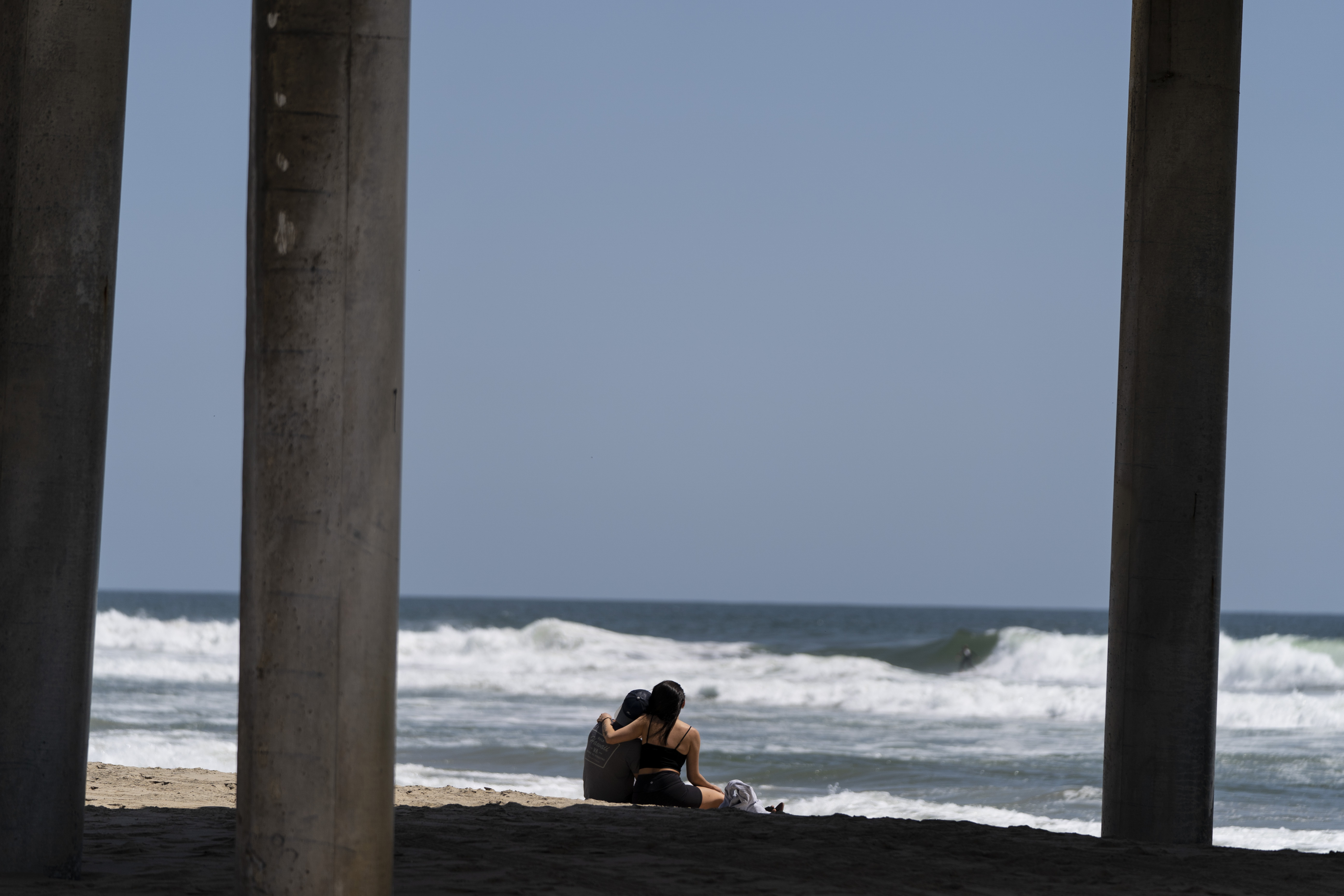 A young couple sit on the beach in Huntington Beach, Calif., Monday, May 8, 2023. For years, studies have shown a decline in the rates of American high school students having sex. That trend continued, not surprisingly, in the first years of the pandemic, according to a recent survey by the Centers for Disease Control and Prevention. The study found that 30% of teens in 2021 said they had ever had sex, down from 38% in 2019 and a huge drop from three decades ago when more than half of teens reported having sex. (AP Photo/Jae C. Hong)