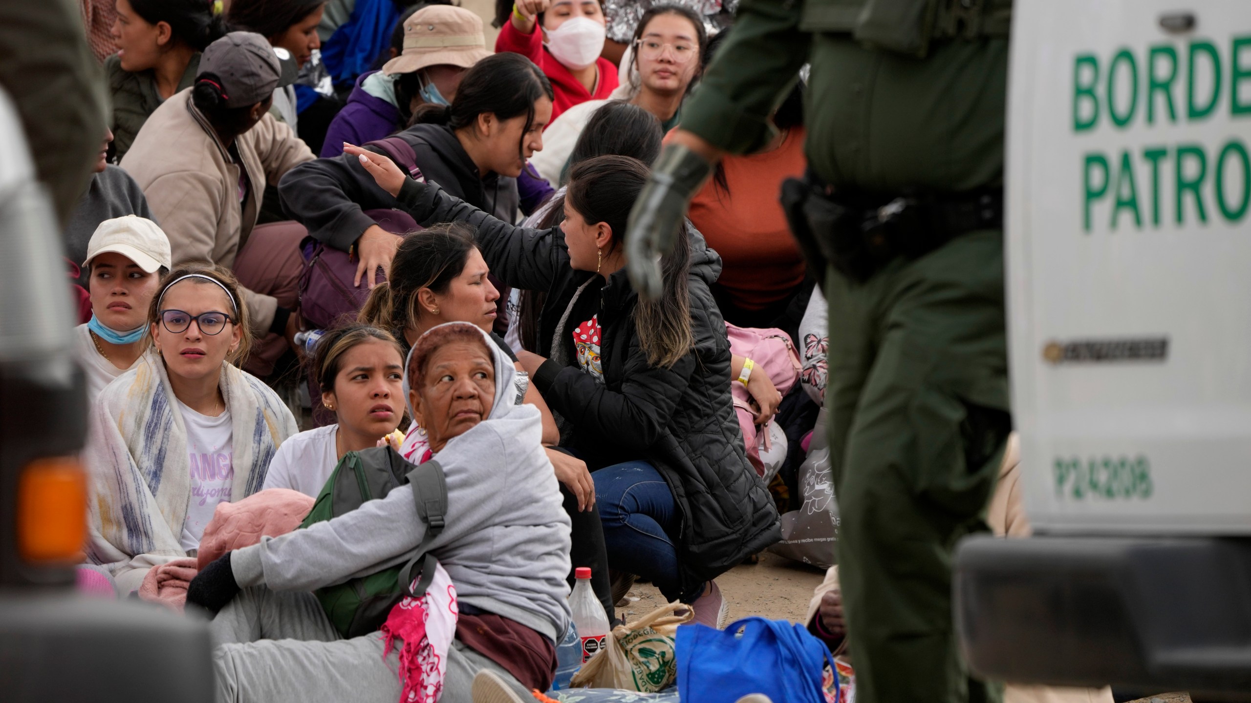 People wait to apply for asylum between two border walls Thursday, May 11, 2023, in San Diego. Many of the hundreds of migrants between the walls that separate Tijuana, Mexico, with San Diego have been waiting for days to apply for asylum. Pandemic-related U.S. asylum restrictions, known as Title 42, are to expire May 11. (AP Photo/Gregory Bull)