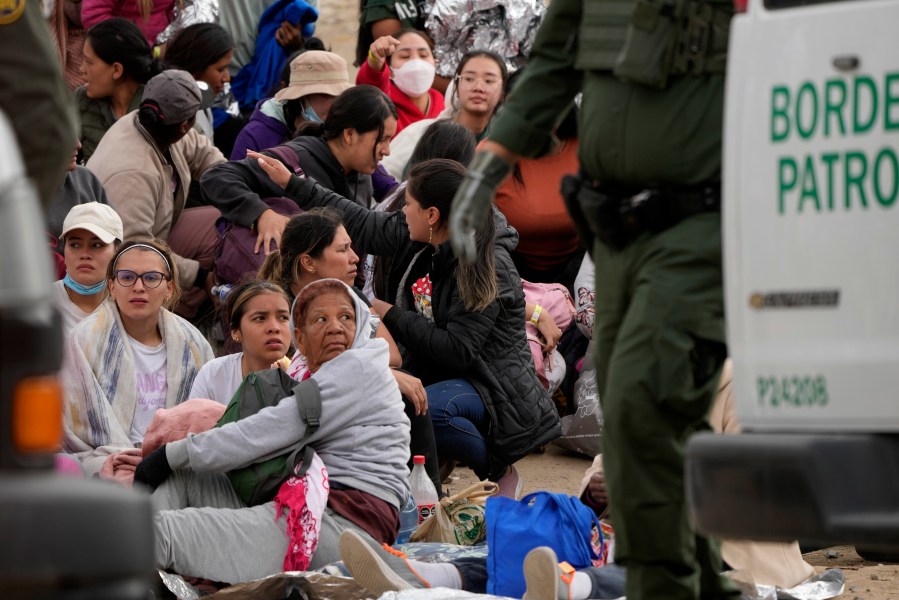 People wait to apply for asylum between two border walls Thursday, May 11, 2023, in San Diego. Many of the hundreds of migrants between the walls that separate Tijuana, Mexico, with San Diego have been waiting for days to apply for asylum. Pandemic-related U.S. asylum restrictions, known as Title 42, are to expire May 11. (AP Photo/Gregory Bull)