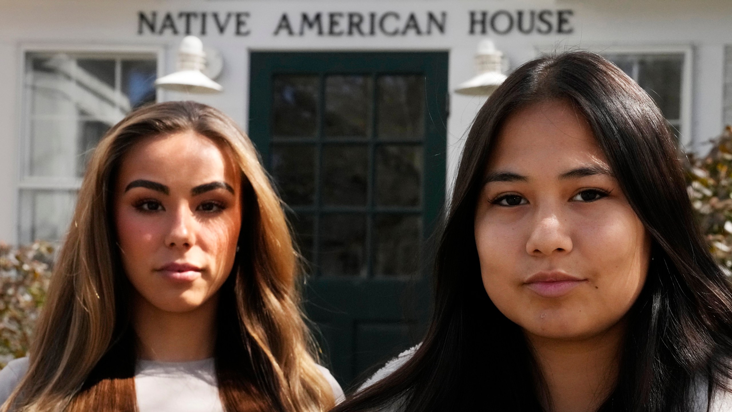 Dartmouth College students Marisa Joseph, right, a member of the Tulalip Tribes of Washington, poses with Ahnili Johnson-Jennings, left, a member of the Quapaw, Choctaw, Sac and Fox and Miami tribes, pose outside the Native American House at Dartmouth College, Friday, April 7, 2023, in Hanover, N.H. The college announced in March 2023 that it housed partial Native American skeletal remains in their collection. Dartmouth has set in motion an effort to repatriate the remains to the appropriate tribes. (AP Photo/Charles Krupa)