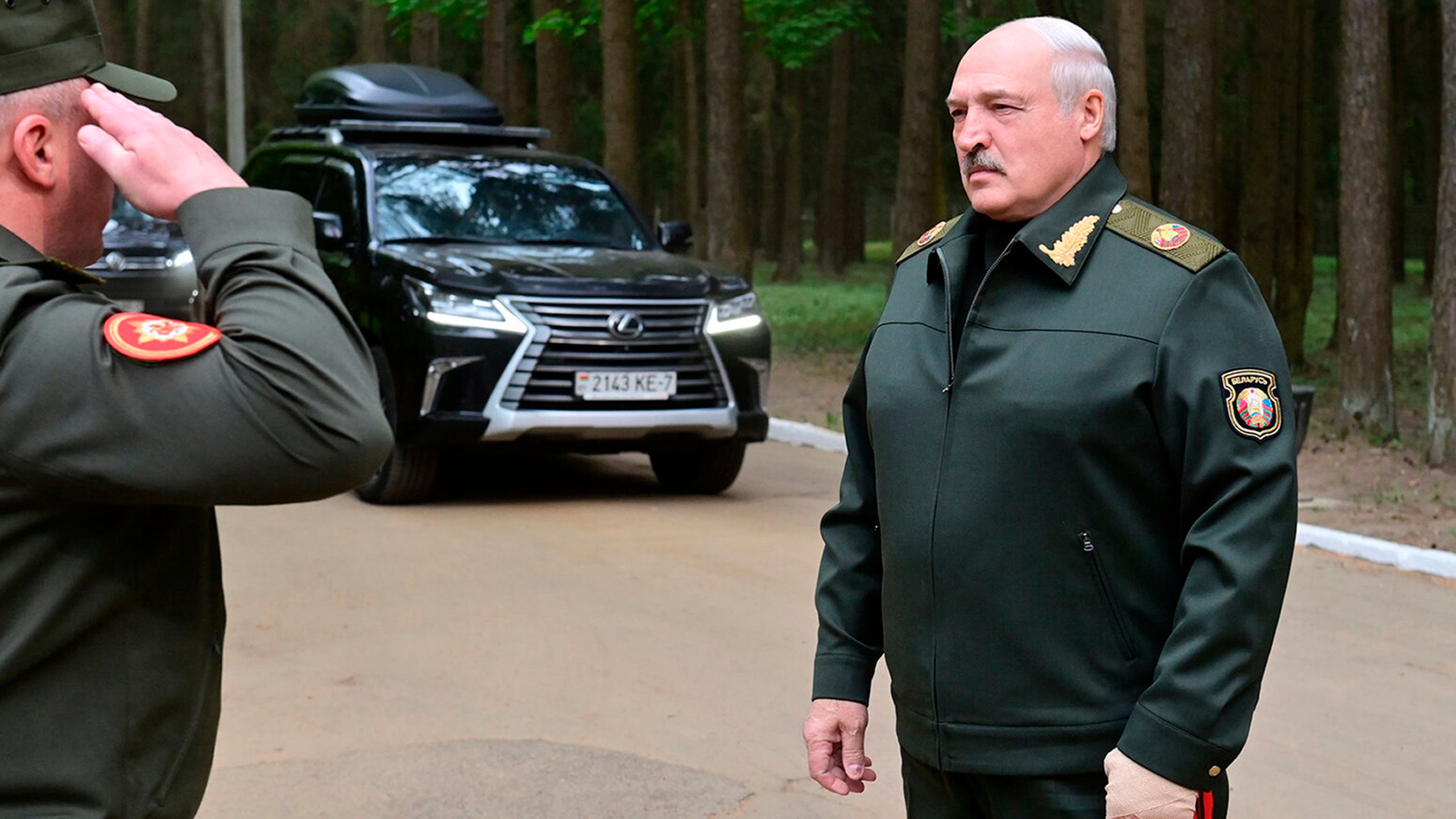 In this handout photo released by Belarus' Presidential Press Office, Belarusian President Alexander Lukashenko listens to an officer's report as he arrives to visit the Central Command Post of the Air Force and Air Defense Forces in Belarus, Monday, May 15, 2023. (Belarus' Presidential Press Office via AP)