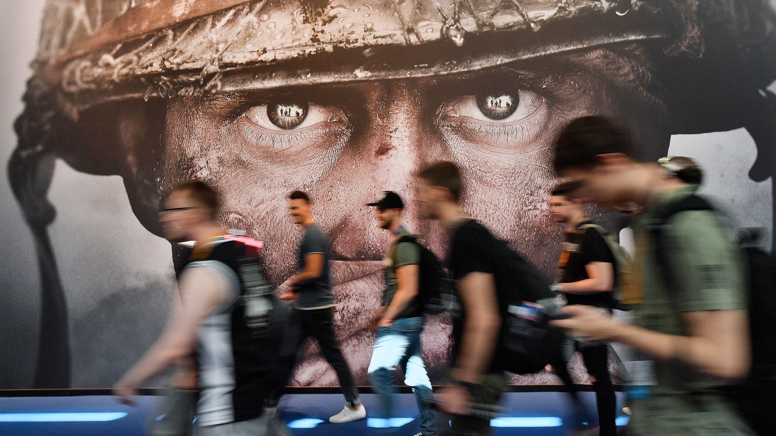 FILE - Visitors passing an advertisement for the video game 'Call of Duty' at the Gamescom fair for computer games in Cologne, Germany, on Aug. 22, 2017. The European Union on Monday approved Microsoft’s $69 billion purchase of video game maker Activision Blizzard, deciding the deal won’t stifle competition for popular console titles like Call of Duty and accepting the U.S. tech company’s remedies to boost competition in cloud gaming. (AP Photo/Martin Meissner, File)