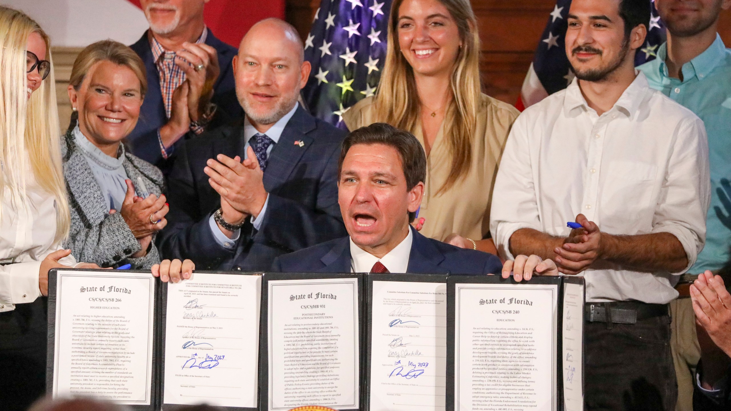 Florida Gov. Ron DeSantis signs legislation on Monday, May 15, 2023, banning state funding for diversity, equity, and inclusion programs at Florida's public universities, at New College of Florida in Sarasota, Fla. (Douglas R. Clifford/Tampa Bay Times via AP)