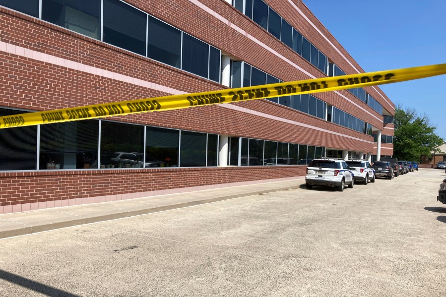 Crime scene tape blocks the Fairfax, Va., office building where police say a man wielding a baseball bat attacked two staffers for U.S. Rep. Gerry Connolly, D-Va., on Monday morning, May 15, 2023. (AP Photo/Matthew Barakat)