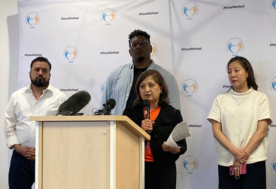 Chanda Parbhoo, at podium, founder and president of SAAVETX Education Fund, speaks at a news conference as, from left rear, Ramiro Luna, executive director and co-founder of Somos Tejas; Jerry Hawkins of Dallas Truth, Racial Healing & Transformation; and community member Caroline Kim listen, Monday, May 15, 2023, in Dallas. Members of Texas groups representing people of color demanded that authorities quickly acknowledge whether they believe the neo-Nazi who killed eight people at a Dallas-area mall over a week ago was racially motivated in choosing his victims. (AP Photo/Jamie Stengle)