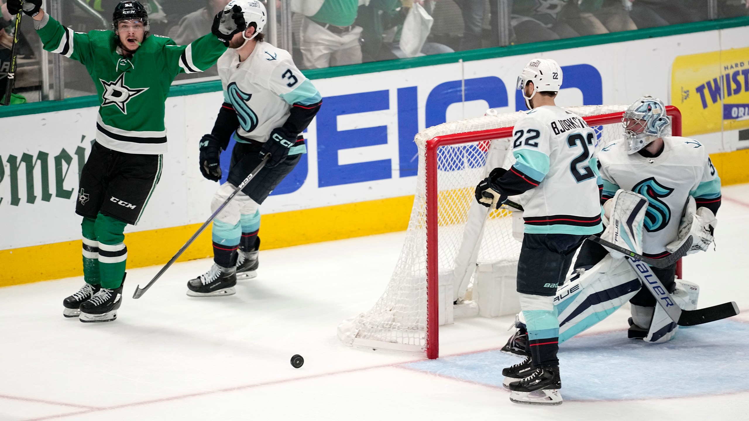 Dallas Stars center Wyatt Johnston, left, celebrates after scoring as Seattle Kraken's Will Borgen (3), Oliver Bjorkstrand (22) and goaltender Philipp Grubauer, right, look on in the third period of Game 7 of an NHL hockey Stanley Cup second-round playoff series, Monday, May 15, 2023, in Dallas. (AP Photo/Tony Gutierrez)