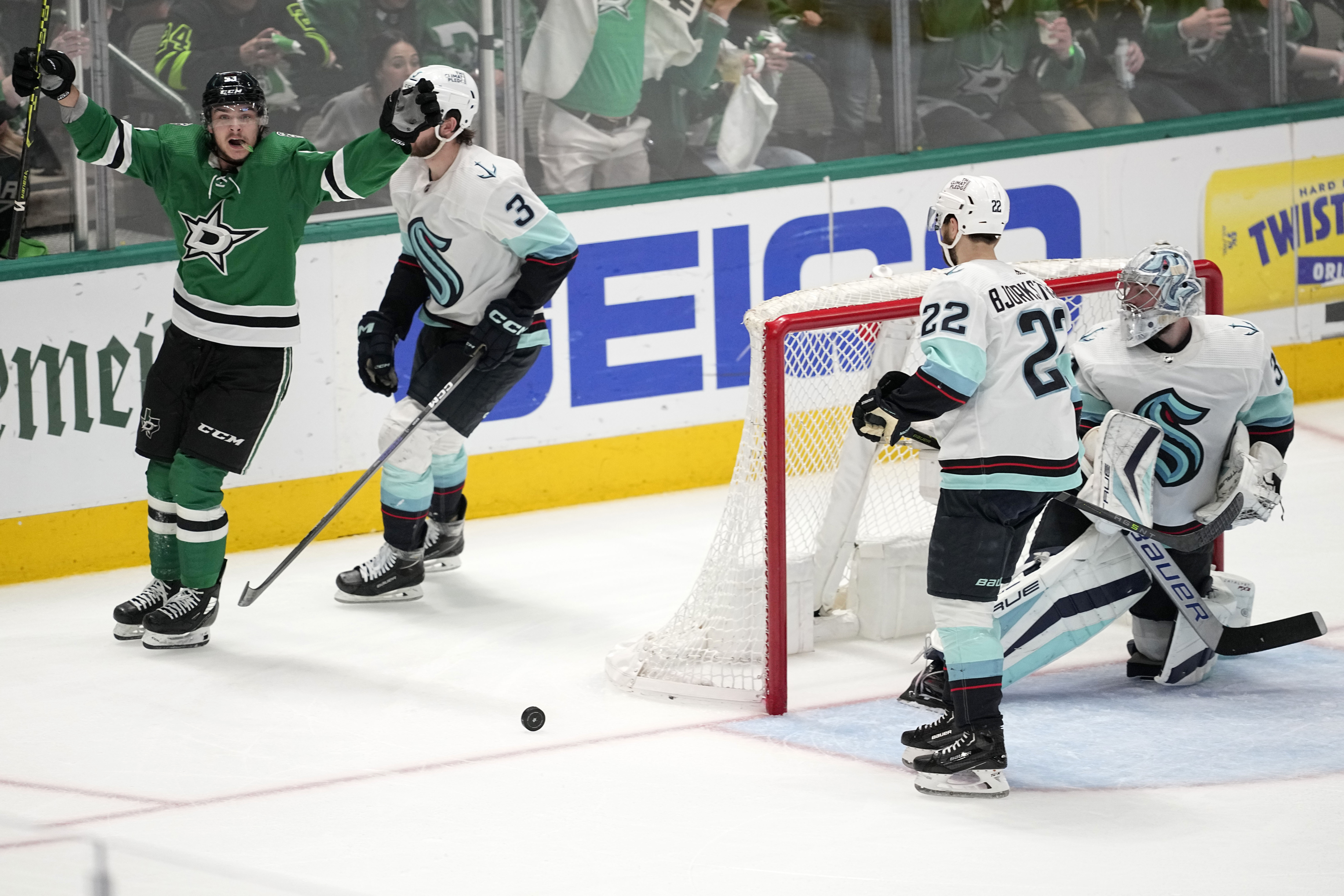 Dallas Stars center Wyatt Johnston, left, celebrates after scoring as Seattle Kraken's Will Borgen (3), Oliver Bjorkstrand (22) and goaltender Philipp Grubauer, right, look on in the third period of Game 7 of an NHL hockey Stanley Cup second-round playoff series, Monday, May 15, 2023, in Dallas. (AP Photo/Tony Gutierrez)