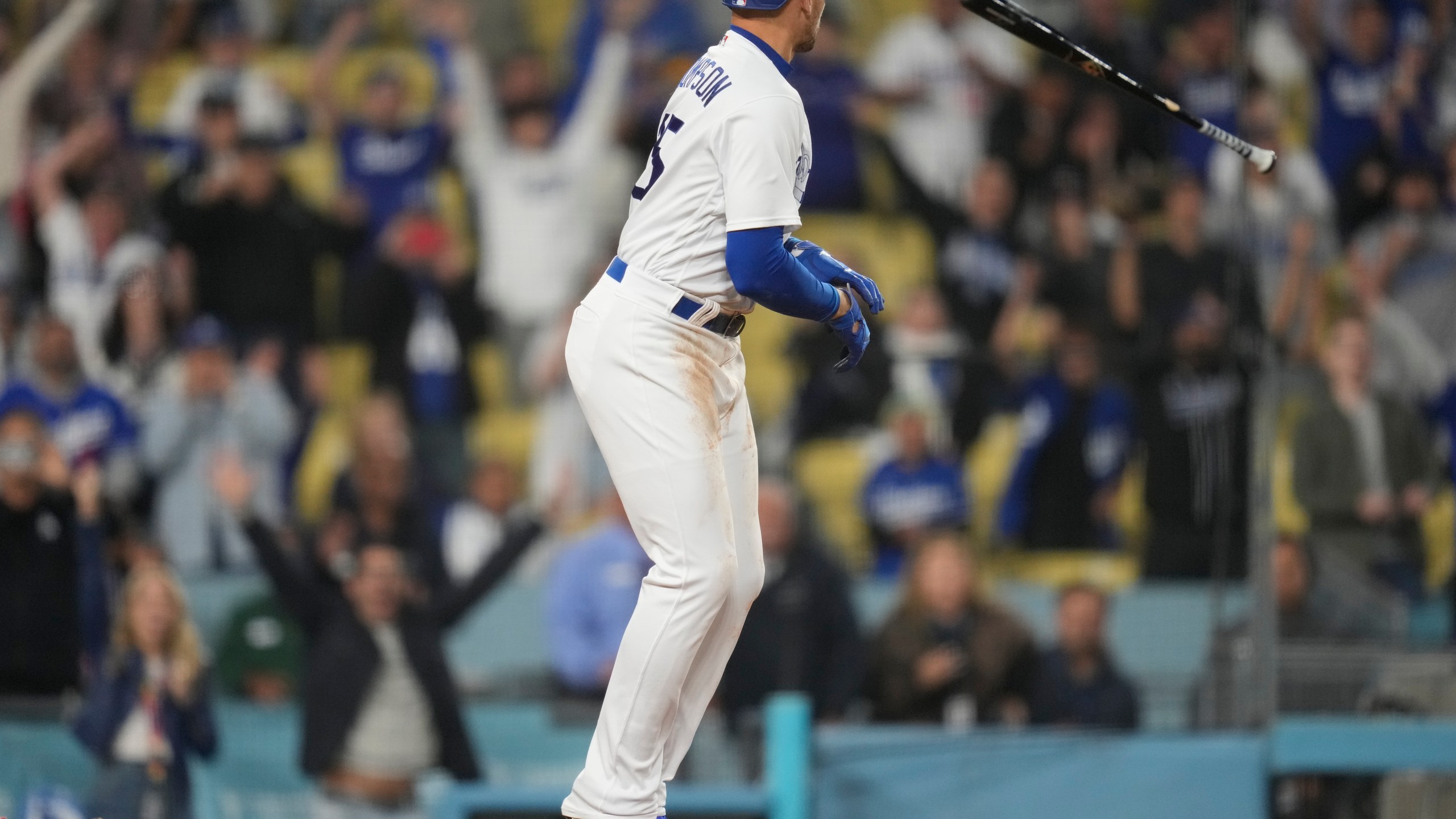 Los Angeles Dodgers' Trayce Thompson (25) tosses his bat as he walks during the twelfth inning of a baseball game against the Minnesota Twins in Los Angeles, Monday, May 15, 2023. Chris Taylor scored to win the game 9-8. (AP Photo/Ashley Landis)