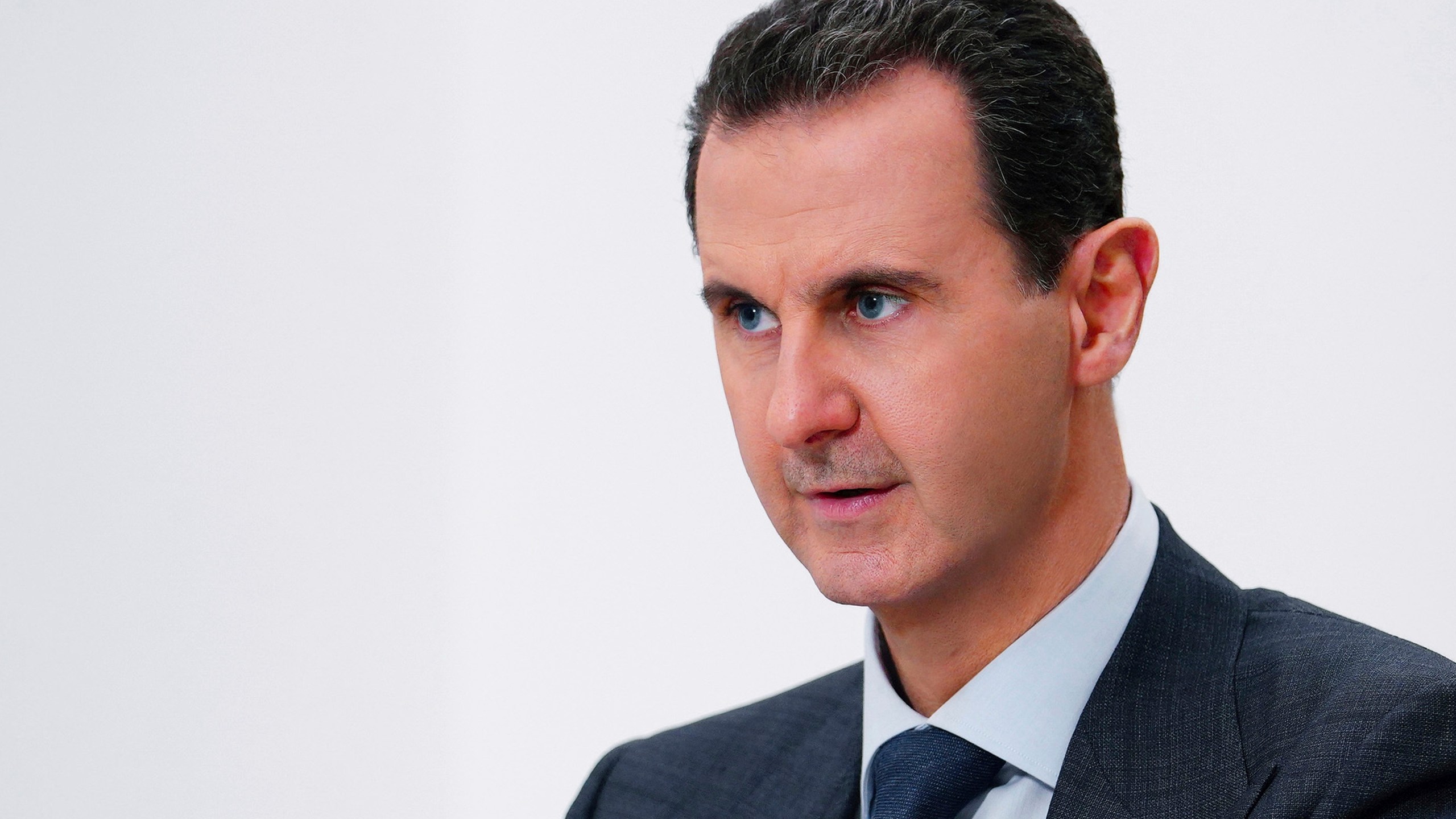 FILE - In this photo released on Nov. 9, 2019 by the Syrian official news agency SANA, Syrian President Bashar Assad speaks in Damascus, Syria. Syria's embattled President Bashar Assad has received late Monday, May 15, 2023 an invitation to attend the upcoming COP28 climate talks in Dubai later this year, even as the yearslong war in his country over his rule grinds on. (SANA via AP, File)