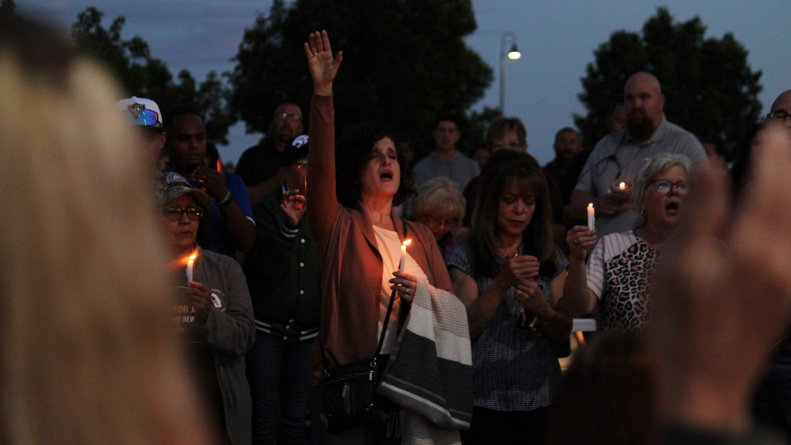 Community members sing during a prayer vigil at Hills Church, Monday, May 15, 2023, in Farmington, N.M. Authorities said an 18-year-old man roamed through the community firing randomly at cars and houses Monday, killing three people and injuring six others including two police officers before he was killed. (AP Photo/Susan Montoya Bryan)