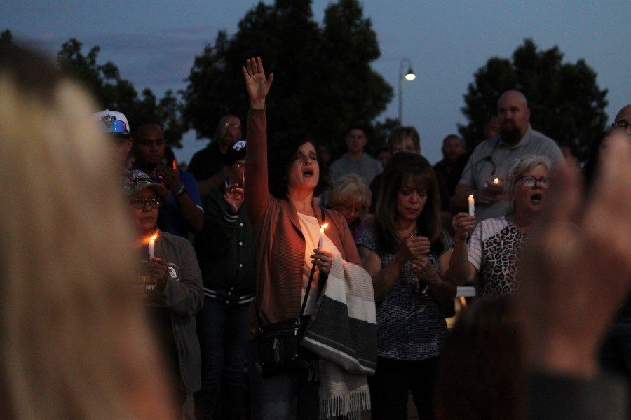 Community members sing during a prayer vigil at Hills Church, Monday, May 15, 2023, in Farmington, N.M. Authorities said an 18-year-old man roamed through the community firing randomly at cars and houses Monday, killing three people and injuring six others including two police officers before he was killed. (AP Photo/Susan Montoya Bryan)