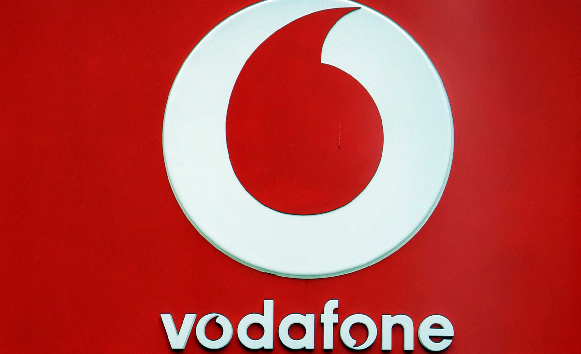 The logo for the Vodafone brand on one of its retail stores in Oxford street in London, Wednesday, Aug. 13, 2008. Mobile phone carrier Vodafone said Tuesday, May 16, 2023 it's laying off 11,000 workers as part of a major revamp aimed at cutting costs and boosting flagging financial performance. (AP Photo/Alastair Grant)