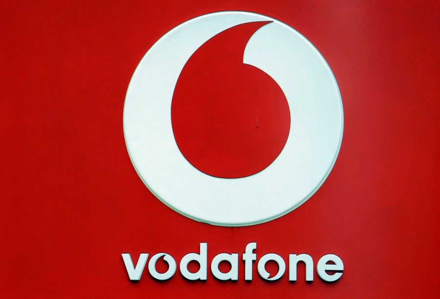 The logo for the Vodafone brand on one of its retail stores in Oxford street in London, Wednesday, Aug. 13, 2008. Mobile phone carrier Vodafone said Tuesday, May 16, 2023 it's laying off 11,000 workers as part of a major revamp aimed at cutting costs and boosting flagging financial performance. (AP Photo/Alastair Grant)