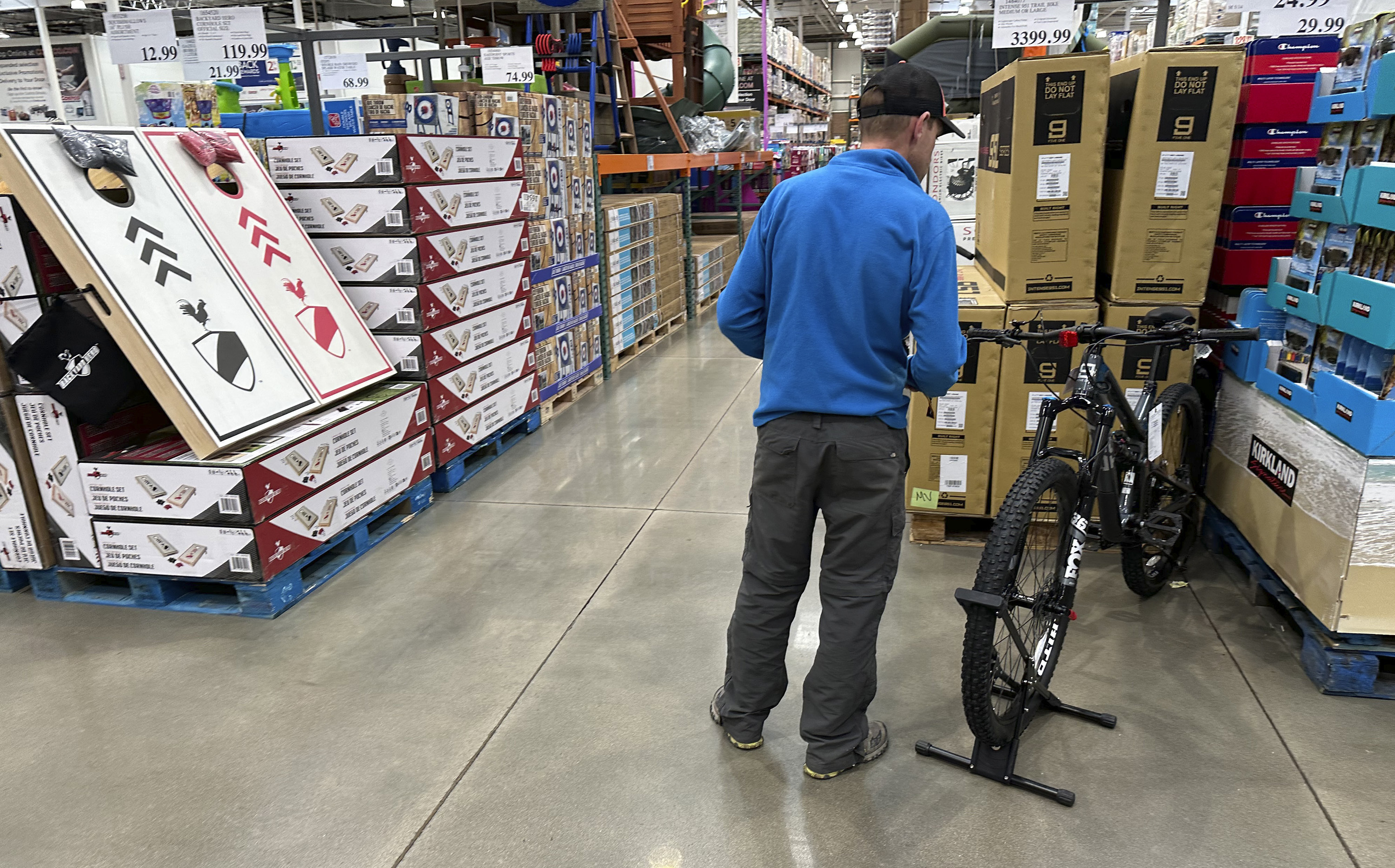 A shopper peruses a mountain bicycle on display in a Costco warehouse Wednesday, May 10, 2023, in Sheridan, Colo. On Tuesday, the Commerce Department releases U.S. retail sales data for April. (AP Photo/David Zalubowski)