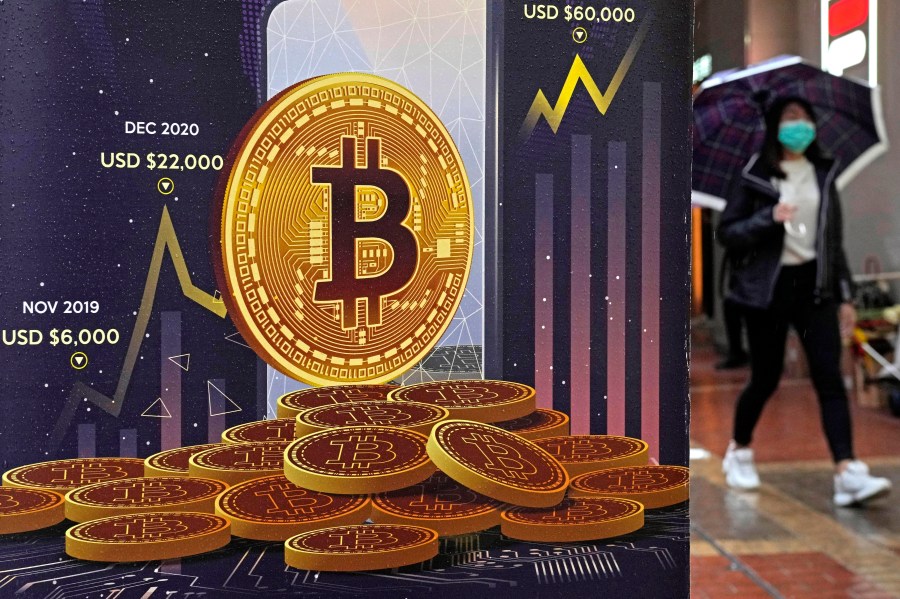 FILE - An advertisement for Bitcoin cryptocurrency is displayed on a street in Hong Kong, on Feb. 17, 2022. The European Union's sweeping set of beefed-up cryptocurrency rules got final approval from member states on Tuesday, giving the bloc a global lead in regulating the freewheeling sector. The European Council adopted the package of rules, known as Markets in Crypto Assets, or MiCA, in the final step in the 27-nation bloc's legislative process. (AP Photo/Kin Cheung, File)