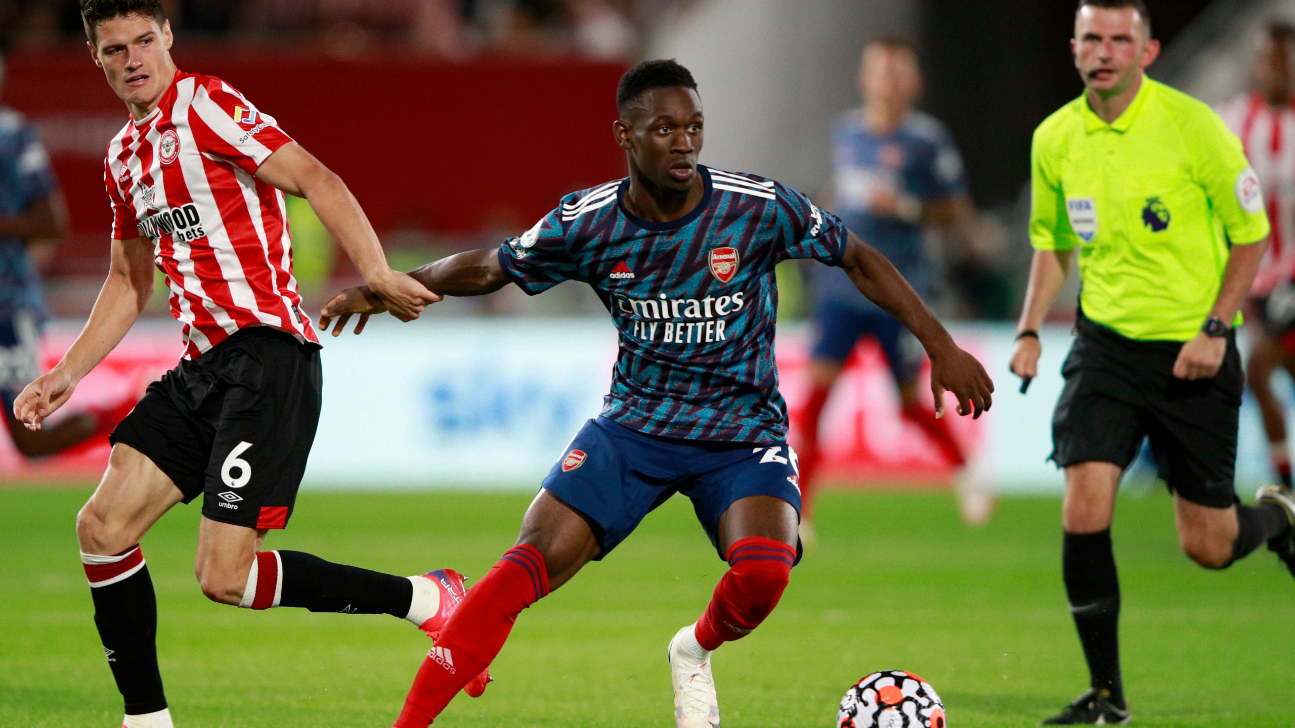 FILE - Brentford's Christian Norgaard vies for the ball with Arsenal's Folarin Balogun, center, during the English Premier League soccer match between Brentford and Arsenal at the Brentford Community Stadium in London, on Aug. 13, 2021. The United States can select Balogun after the England Under-21 forward who has starred in the French league opted to represent the 2026 World Cup co-host. FIFA said on Tuesday May 16, 2023 it approved a request by the U.S. Soccer Federation to change Balogun’s national eligibility from England. The 21-year-old New York-born player also was eligible for Nigeria. (AP Photo/Ian Walton, File)