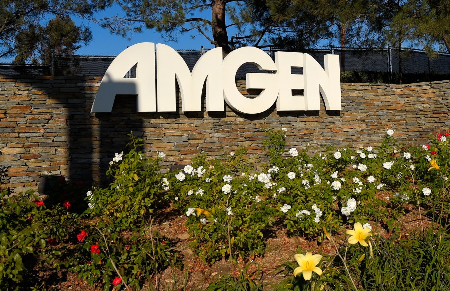 FILE - This photo shows signage outside the Amgen headquarters in Thousand Oaks, Calif on Nov. 9, 2014. Federal regulators are suing to block biotech drug developer Amgen’s more than $26 billion deal for Horizon Therapeutics. The Federal Trade Commission said Tuesday, May 16, 2023, that the deal, announced last December, would give Amgen unfair leverage to block competition for Horizon medications. (AP Photo/Mark J. Terrill, File)