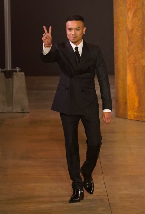 FILE - Bally creative director Rhuigi Villaseñor accepts applause at the end of the Bally women's Spring Summer 2023 collection presented in Milan, Italy, on Sept. 24, 2022. U.S. designer Rhuigi Villasenor is leaving his position as creative director of the Swiss fashion house Bally in a move announced Tuesday, May 16, 2023 as a joint decision. (AP Photo/Alberto Pezzali, File)