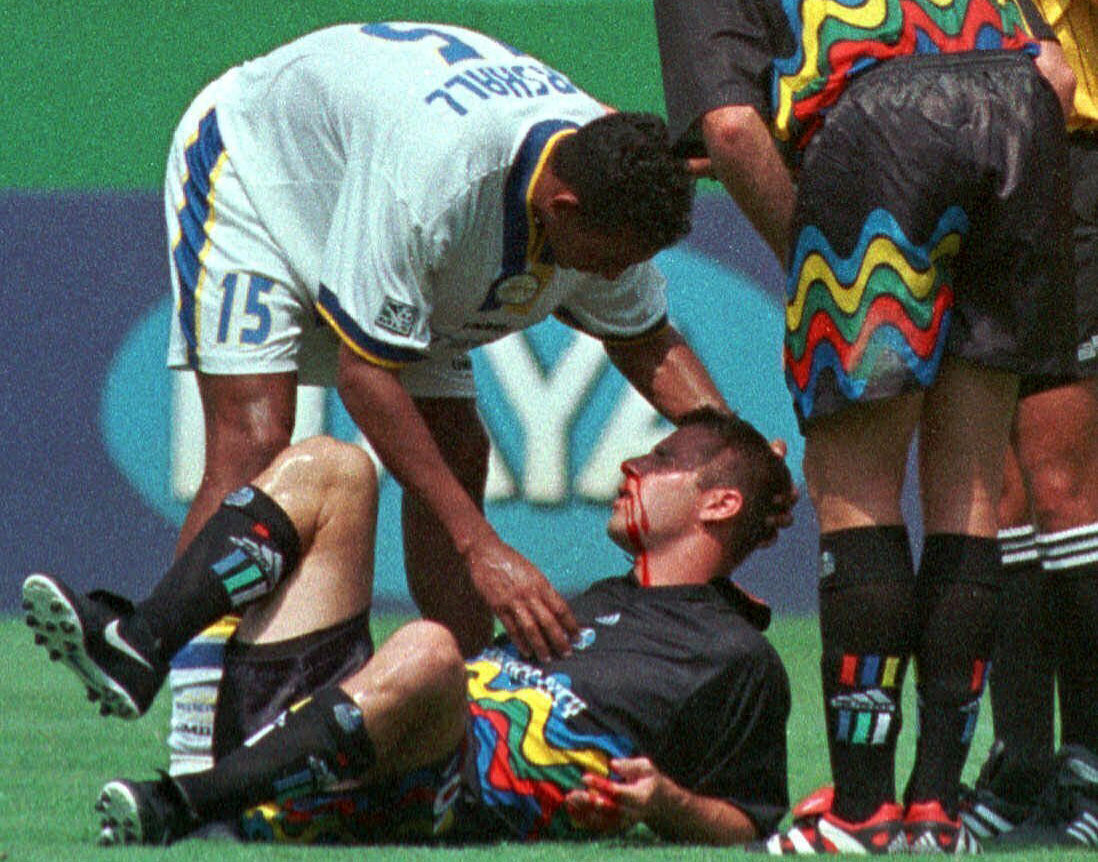 FILE - Miami Fusion's Tyrone Marshall (15) assists Kansas City Wizards' Scott Vermillion after the two collided while going up for a header in the first half of a soccer match Aug. 29, 1999, in Kansas City, Mo. Four more former professional soccer players have been diagnosed with chronic traumatic encephalopathy. The Concussion Legacy Foundation says they were found to have the degenerative brain disease that has been linked to concussions in athletes, combat veterans and others who have sustained repeated head trauma. (AP Photo/Ed Zurga, File)