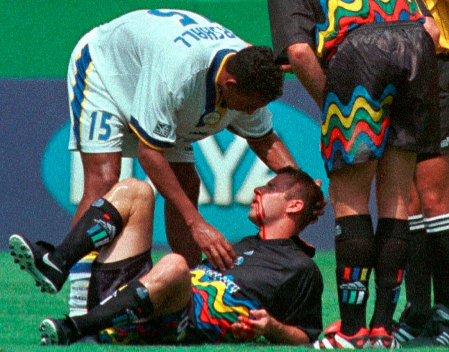 FILE - Miami Fusion's Tyrone Marshall (15) assists Kansas City Wizards' Scott Vermillion after the two collided while going up for a header in the first half of a soccer match Aug. 29, 1999, in Kansas City, Mo. Four more former professional soccer players have been diagnosed with chronic traumatic encephalopathy. The Concussion Legacy Foundation says they were found to have the degenerative brain disease that has been linked to concussions in athletes, combat veterans and others who have sustained repeated head trauma. (AP Photo/Ed Zurga, File)