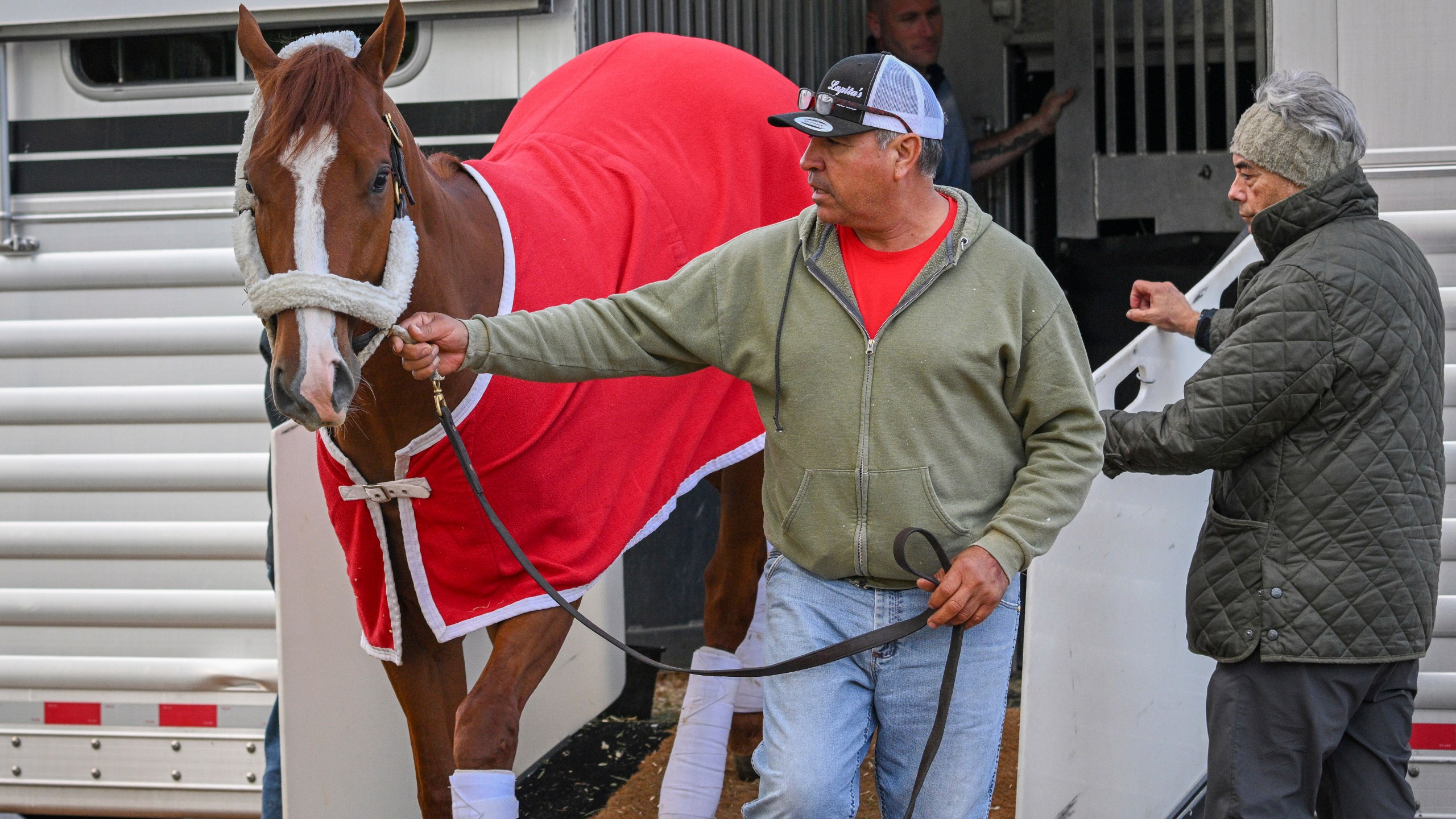 Kentucky Derby winner Mage arrives at Pimlico Race Course early Sunday, May 14, 2023 to prepare for this weekend's Preakness Stakes as trainer Gustavo Delgado, Sr., right, looks on. (Jerry Jackson/The Baltimore Sun via AP)