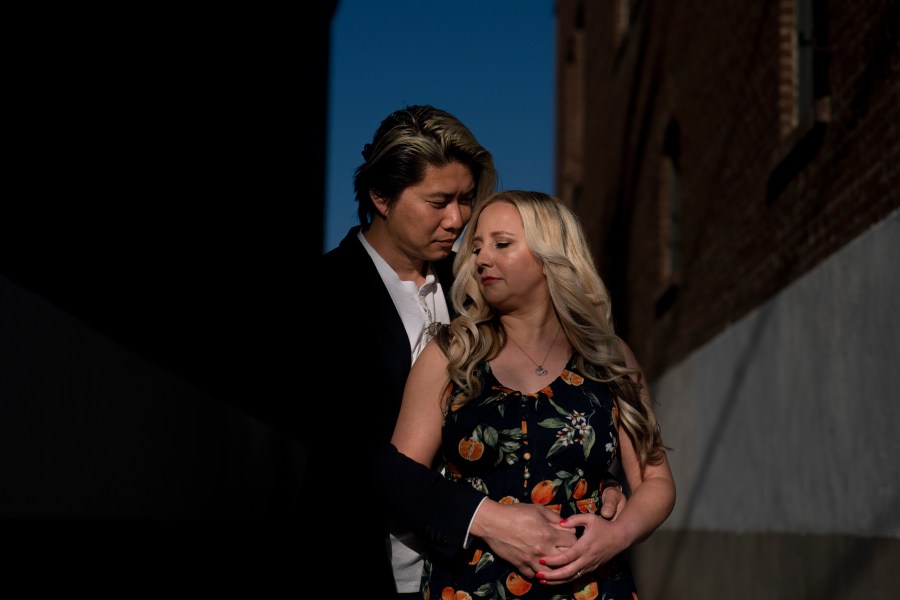 Jessica Tincopa and her husband, Rob Tran, stand for a portrait in Orange, Calif., Friday, May 5, 2023. Tincopa may leave the photography business she spent 14 years building for one reason: to find coverage for fertility treatment. After six miscarriages, Tincopa and her husband started saving for in vitro fertilization, which can cost well over $20,000, but the pandemic wiped out their savings and the state's health insurance marketplace doesn't cover things like IVF. (AP Photo/Jae C. Hong)