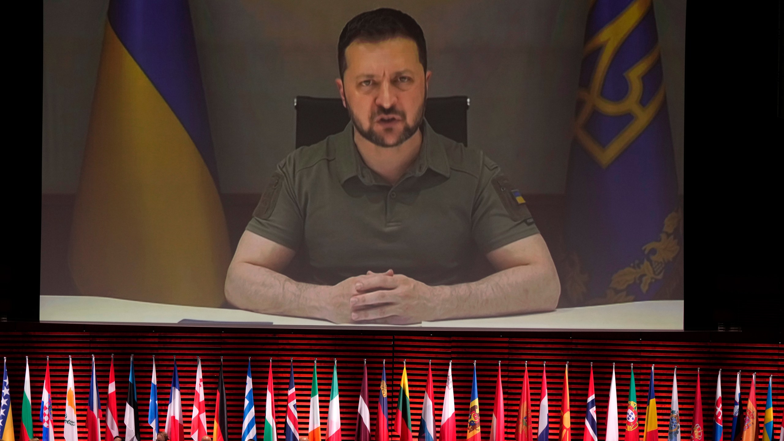 Ukraine's President Volodymyr Zelenskyy addresses, via videolink, the opening ceremony of the Council of Europe summit in Reykjavik, Iceland, Tuesday, May 16, 2023. Leaders from across the continent are laser-focused on holding Russia to account for its invasion of Ukraine and were poised to approve a system during their Council of Europe summit that would precisely establish the damages Moscow would have to pay to rebuild the nation. (AP Photo/Alastair Grant, Pool)