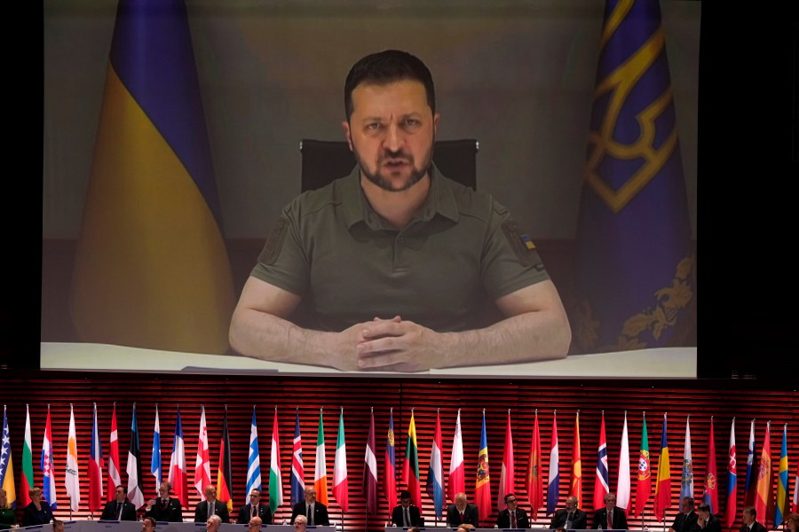 Ukraine's President Volodymyr Zelenskyy addresses, via videolink, the opening ceremony of the Council of Europe summit in Reykjavik, Iceland, Tuesday, May 16, 2023. Leaders from across the continent are laser-focused on holding Russia to account for its invasion of Ukraine and were poised to approve a system during their Council of Europe summit that would precisely establish the damages Moscow would have to pay to rebuild the nation. (AP Photo/Alastair Grant, Pool)