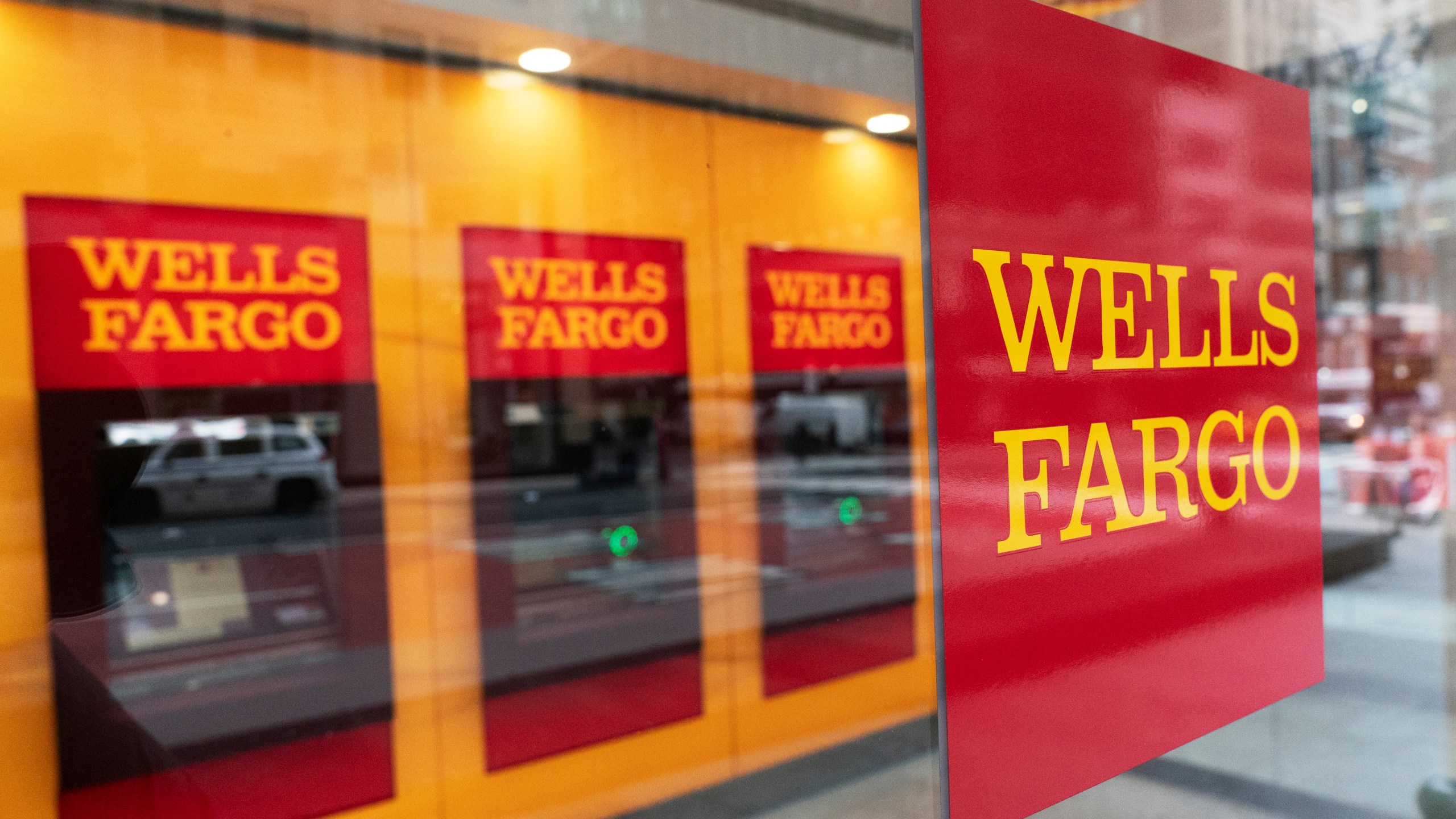 FILE - A Wells Fargo bank sign hangs outside a window on Jan. 13, 2021, in New York. A judge on Tuesday, May 16, 2023, granted preliminary approval of a deal under which Wells Fargo will pay $1 billion to settle a class-action lawsuit filed by shareholders. The shareholders alleged the bank made misleading statements about its compliance with federal regulators after a fake account-opening scandal that came to light in 2016. (AP Photo/Mark Lennihan, File)