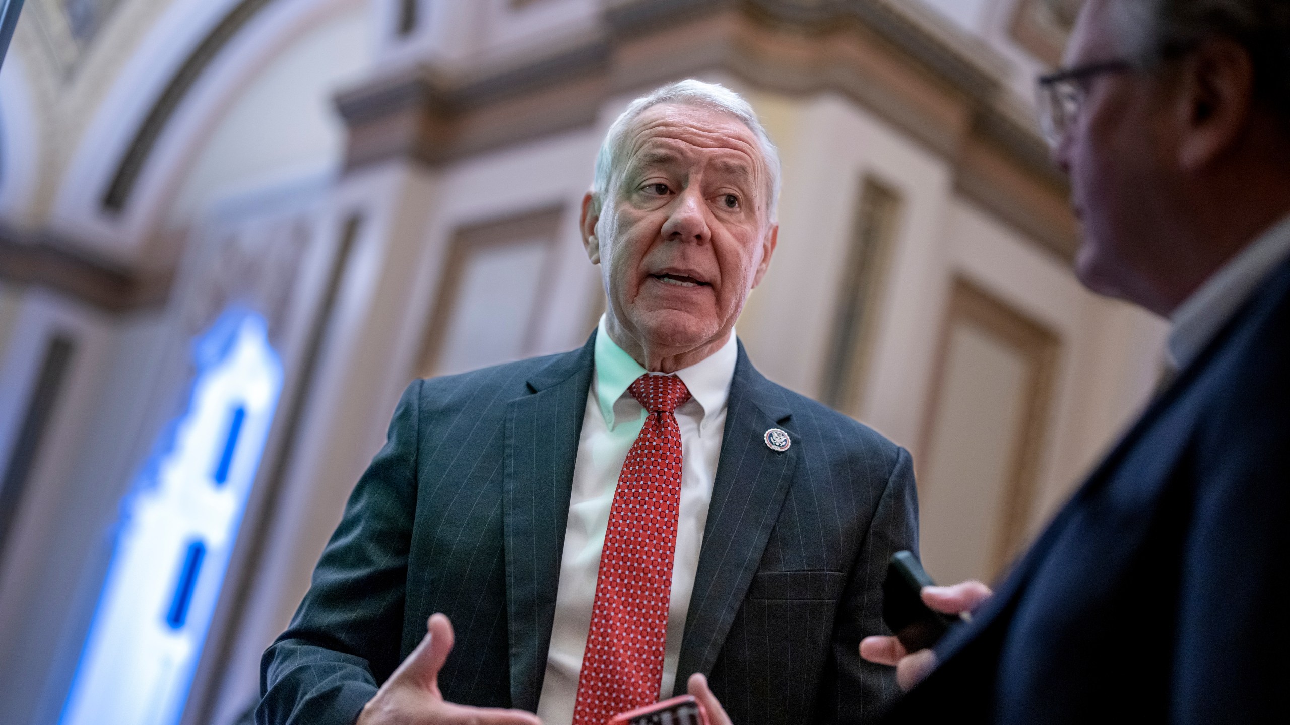 Rep. Ken Buck stops for a reporter as he heads to the chamber for votes