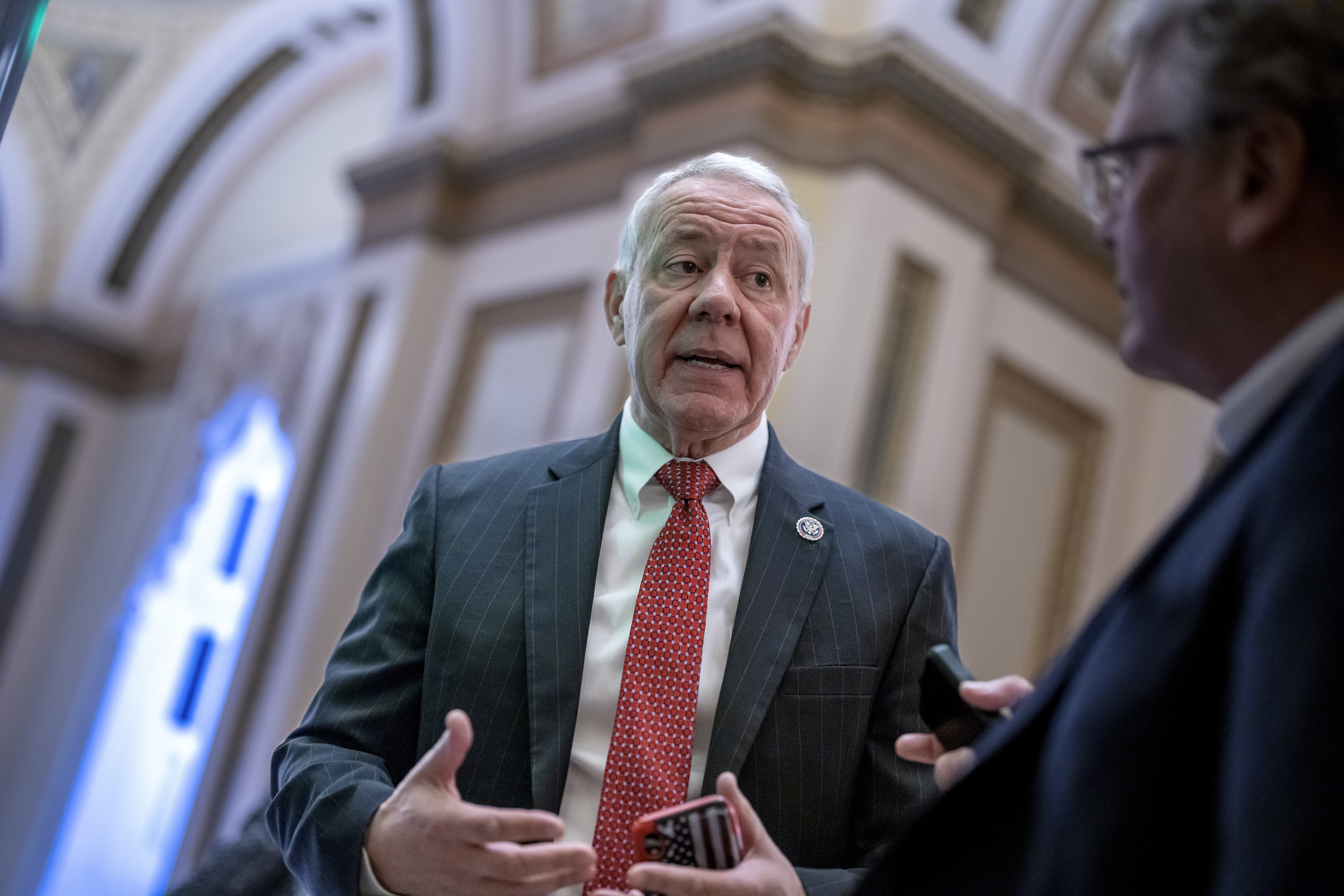 Rep. Ken Buck stops for a reporter as he heads to the chamber for votes