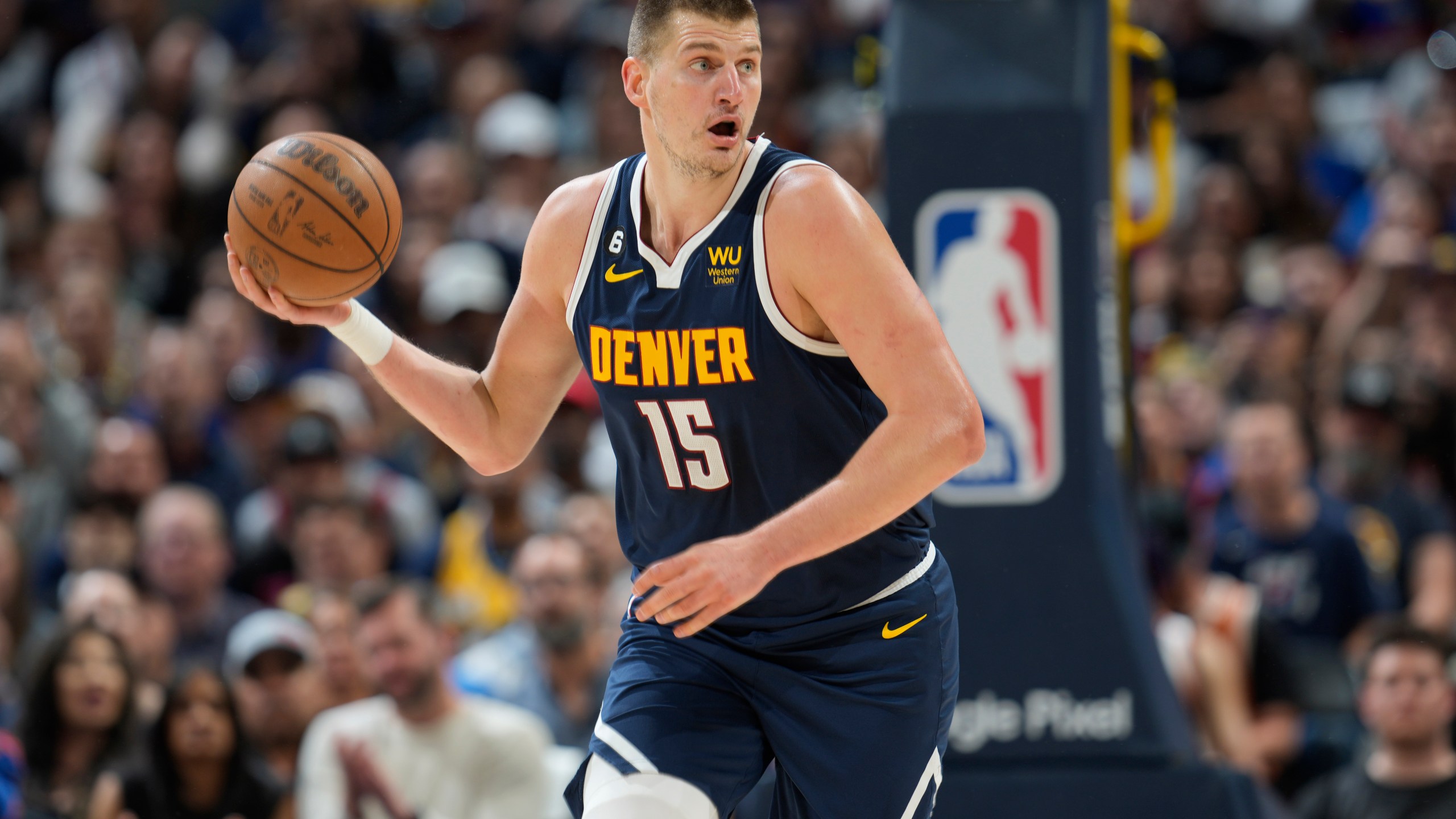 Denver Nuggets center Nikola Jokic picks up the ball