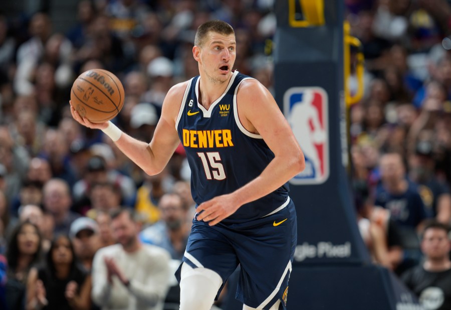 Denver Nuggets center Nikola Jokic picks up the ball