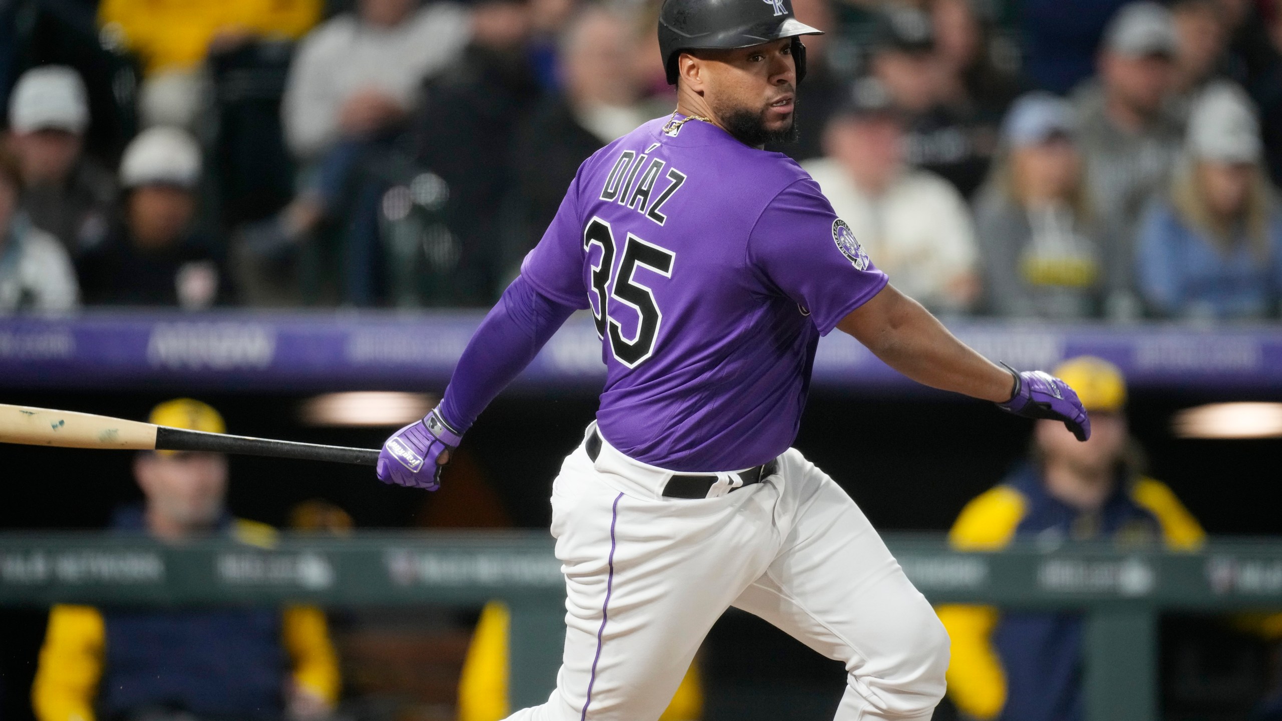 Colorado Rockies' Elias Diaz follows the flight of his RBI-single to drive in the go-ahead run off Milwaukee Brewers relief pitcher Peter Strzelecki