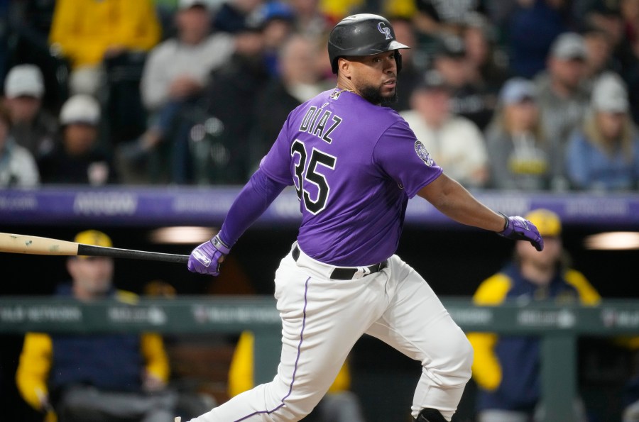 Colorado Rockies' Elias Diaz follows the flight of his RBI-single to drive in the go-ahead run off Milwaukee Brewers relief pitcher Peter Strzelecki