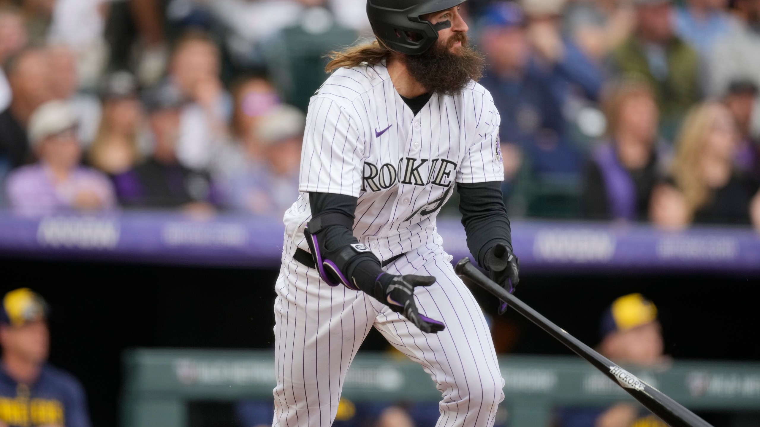 Colorado Rockies' Charlie Blackmon follows the flight of his single to drive in two runs off Milwaukee Brewers starting pitcher Tyson Miller