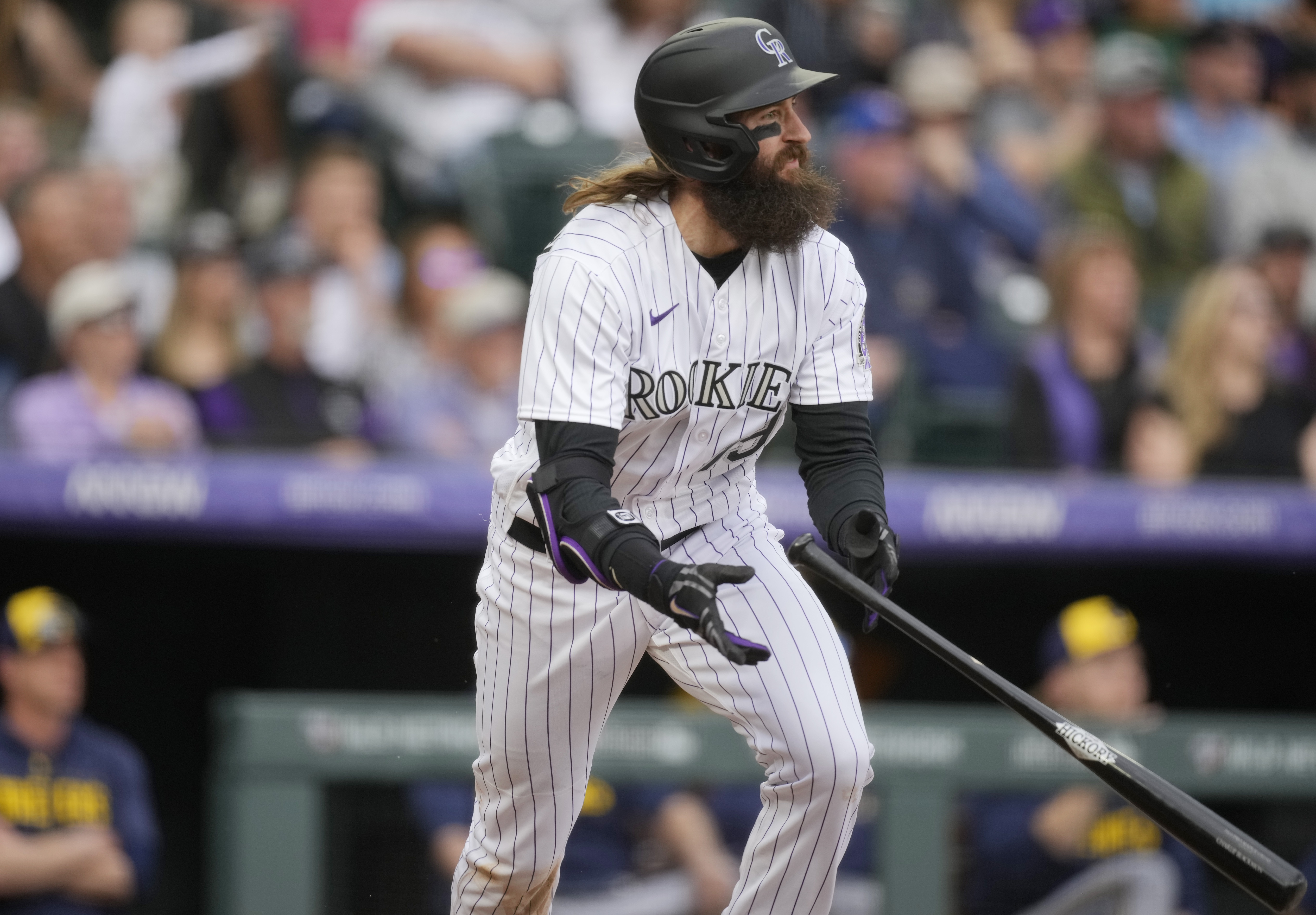 Colorado Rockies' Charlie Blackmon follows the flight of his single to drive in two runs off Milwaukee Brewers starting pitcher Tyson Miller