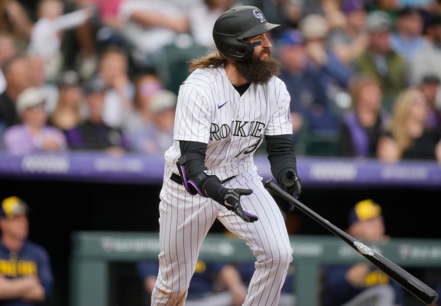 Colorado Rockies' Charlie Blackmon follows the flight of his single to drive in two runs off Milwaukee Brewers starting pitcher Tyson Miller