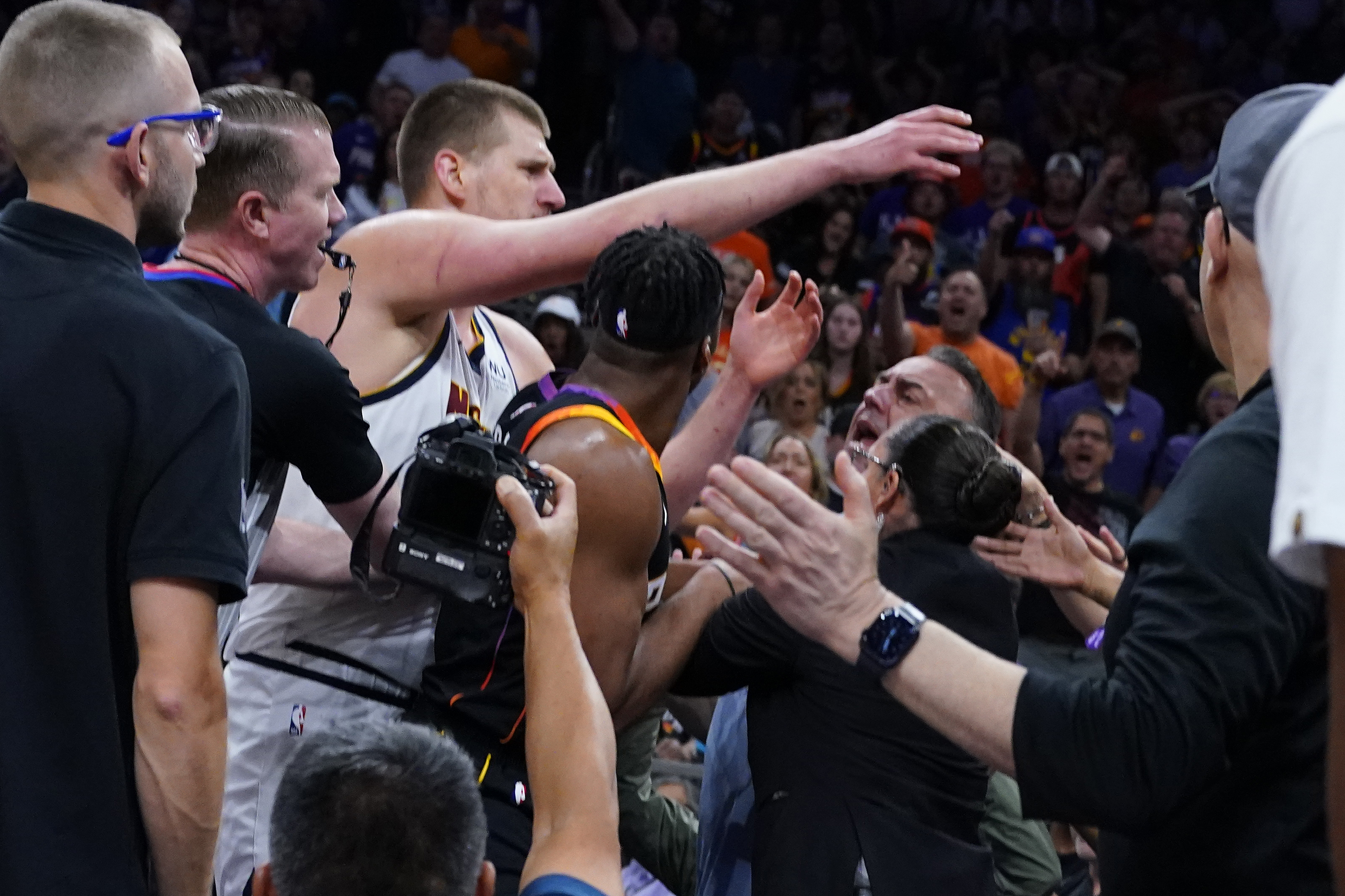 Denver Nuggets center Nikola Jokic get into an altercation in the stands